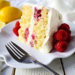 The Best Lemon Raspberry Cake. A light and fluffy lemon cake with fresh raspberries and a fresh lemon cream cheese frosting. A sweet and tangy lemon berry cake! #lemoncake #cake #lemonraspberrycake