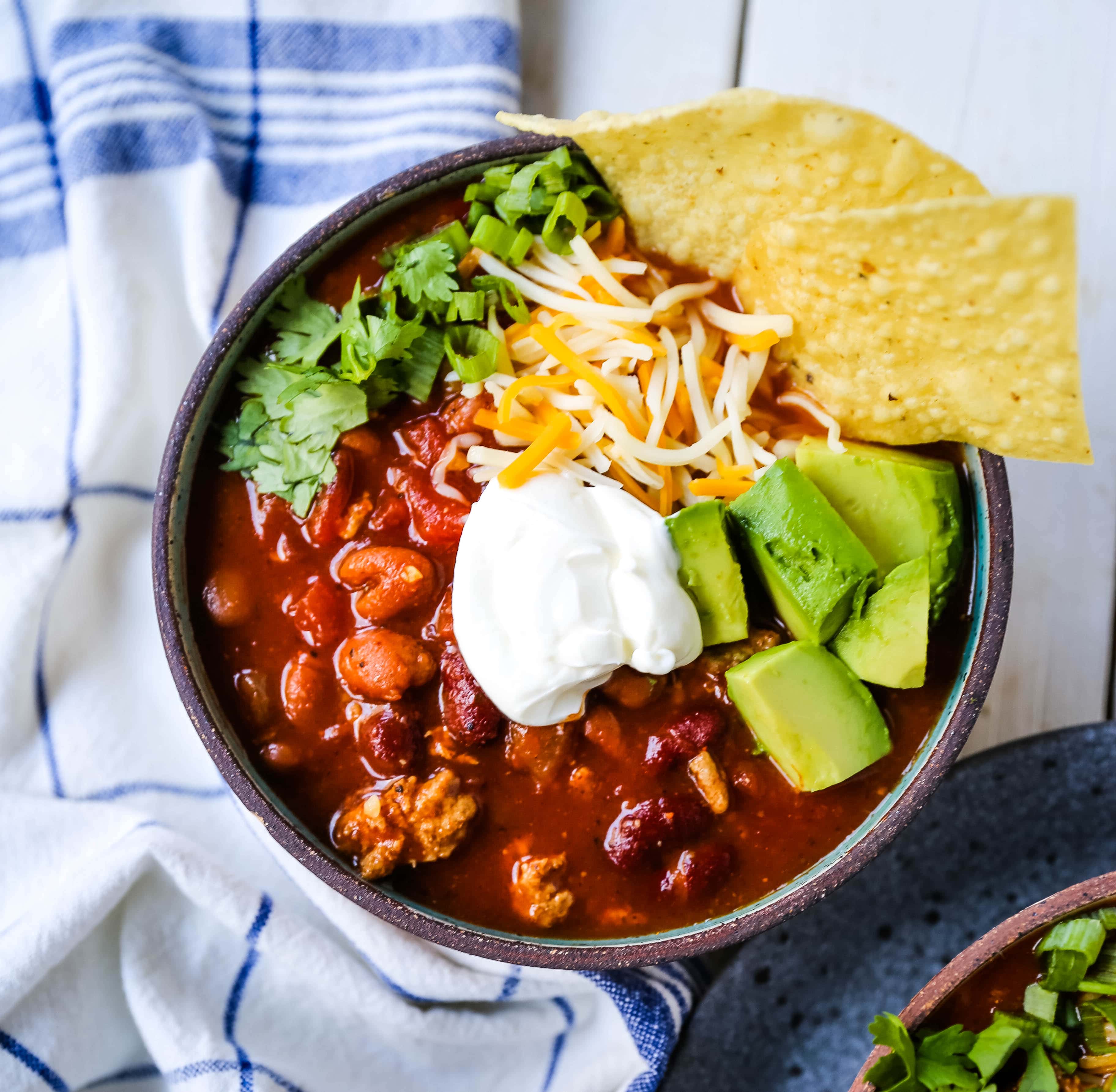 The Best Turkey Chili Recipe Lean Ground Turkey, Seasoned Chili Beans, Tomato sauce, Spices and a few secret ingredients make this the best turkey chili recipe ever! www.modernhoney.com #turkeychili #chilirecipe #fall #fallrecipes 