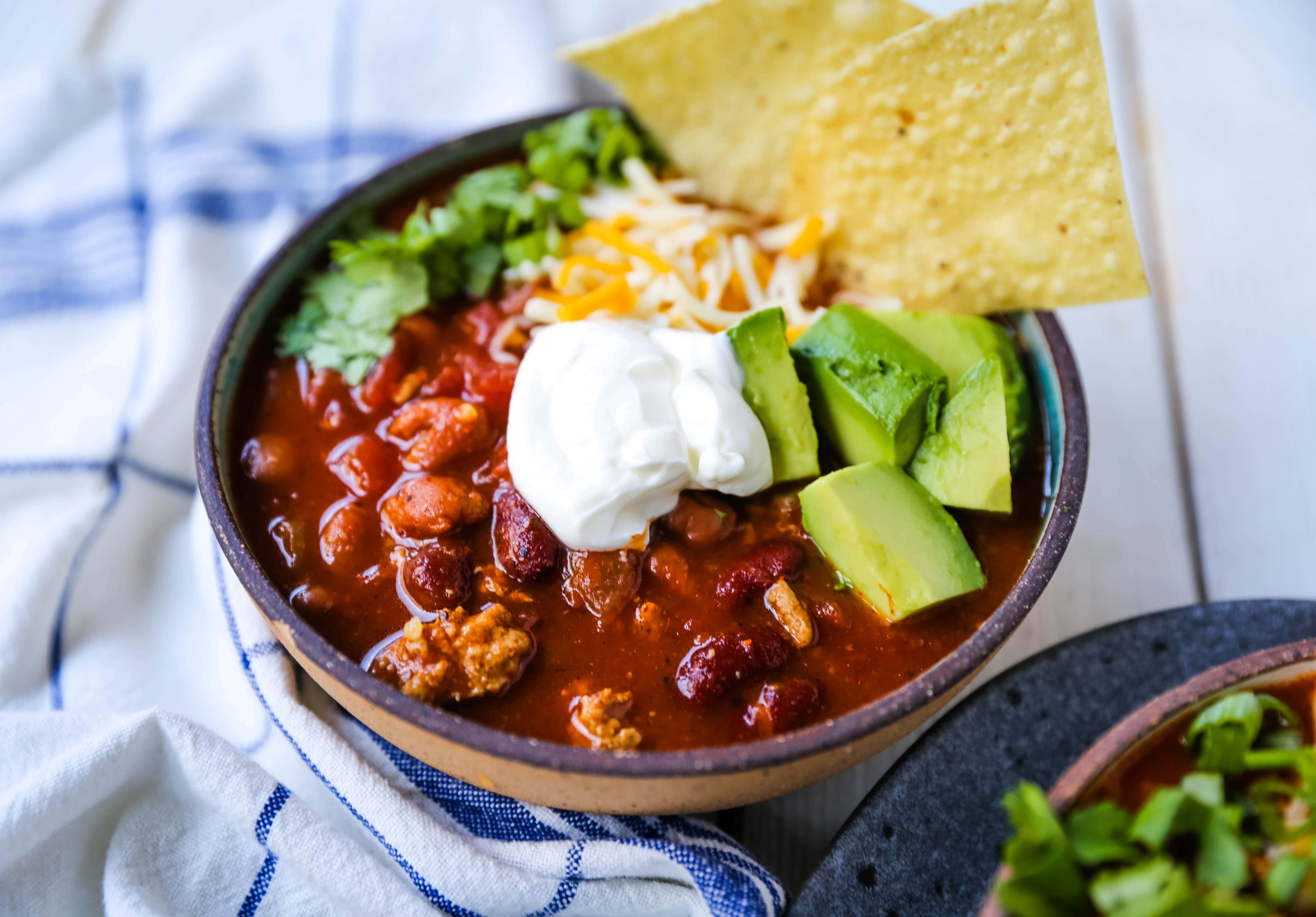 The Best Turkey Chili Recipe Lean Ground Turkey, Seasoned Chili Beans, Tomato sauce, Spices and a few secret ingredients make this the best turkey chili recipe ever! www.modernhoney.com #turkeychili #chilirecipe #fall #fallrecipes 