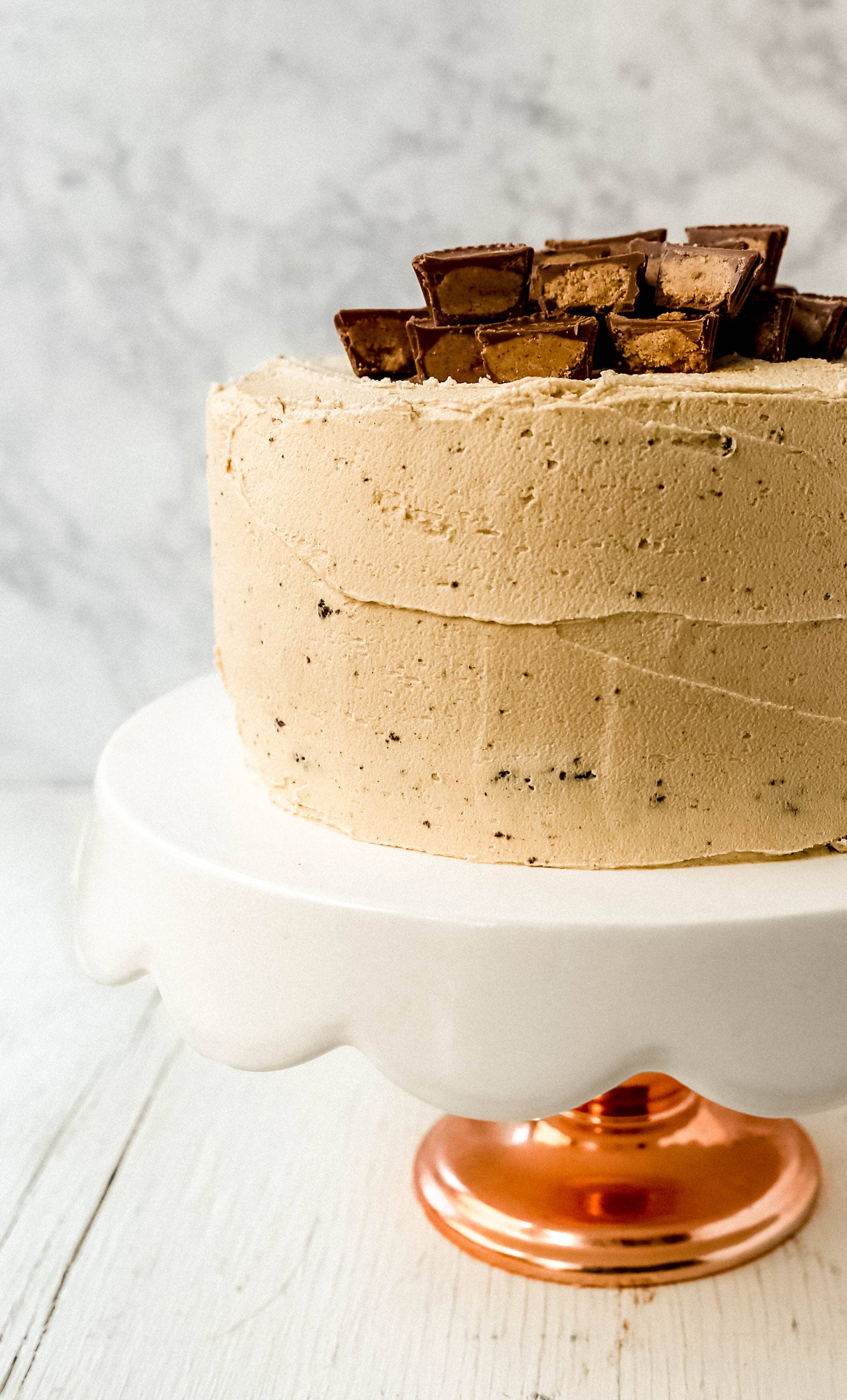 Chocolate Cake with Peanut Butter Frosting A moist 5-Star Rated Chocolate Cake with Creamy Peanut Butter Frosting topped with Peanut Butter Cups. www.modernhoney.com #peanutbutter #chocolatepeanutbuttercake #chocolatecake