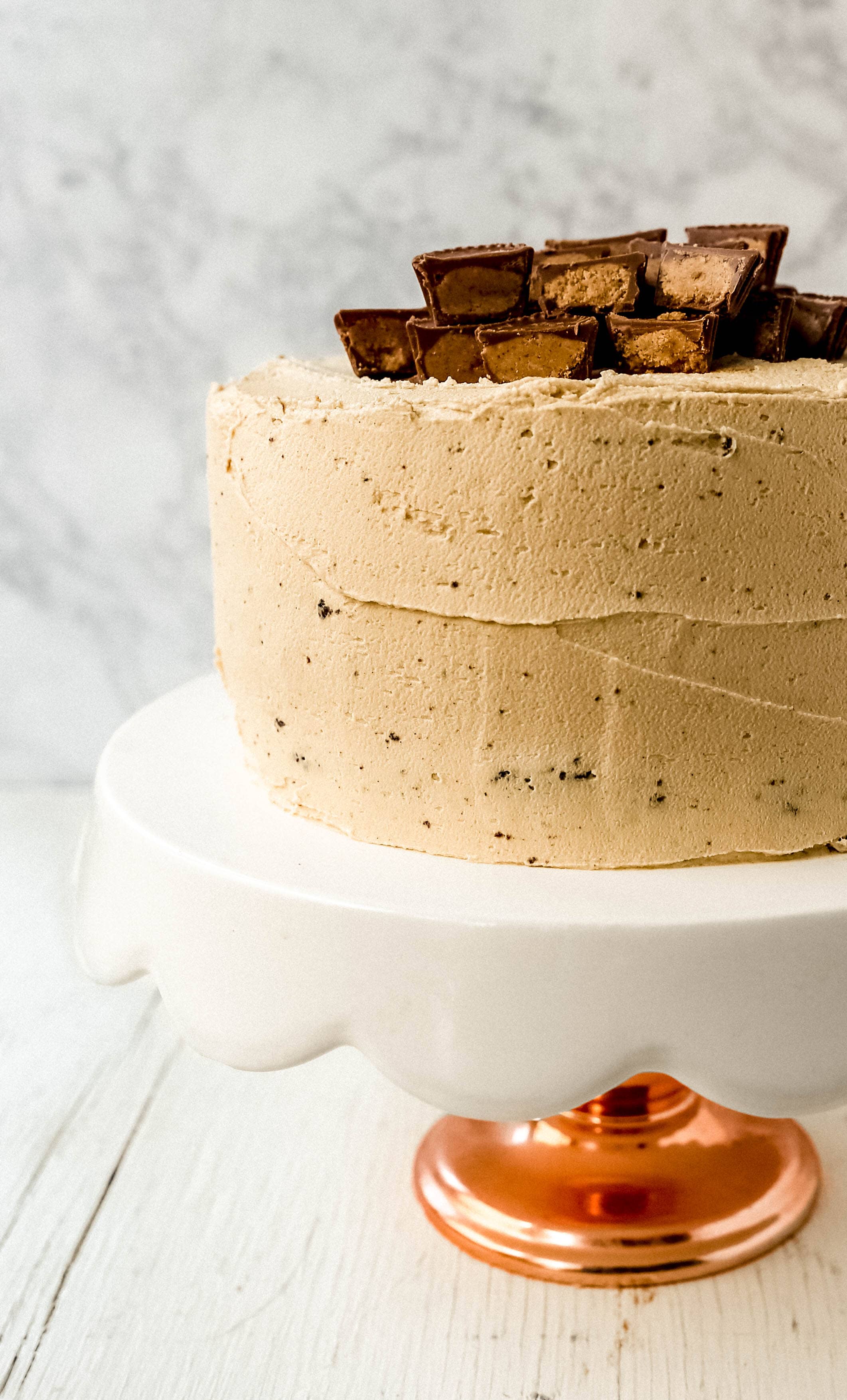 Chocolate Cake with Peanut Butter Frosting A moist 5-Star Rated Chocolate Cake with Creamy Peanut Butter Frosting topped with Peanut Butter Cups. www.modernhoney.com #peanutbutter #chocolatepeanutbuttercake #chocolatecake