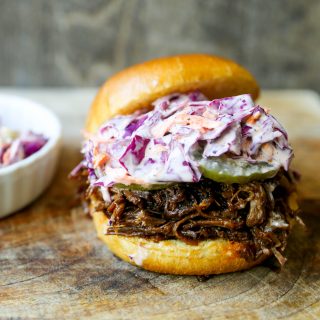 Slow Cooker BBQ Beef Sandwiches Tender seasoned slow cooked beef basted in BBQ sauce and sandwiched between brioche buns and topped with a crunchy coleslaw. www.modernhoney.com #bbqbeef #bbq #crockpot #slowcooker