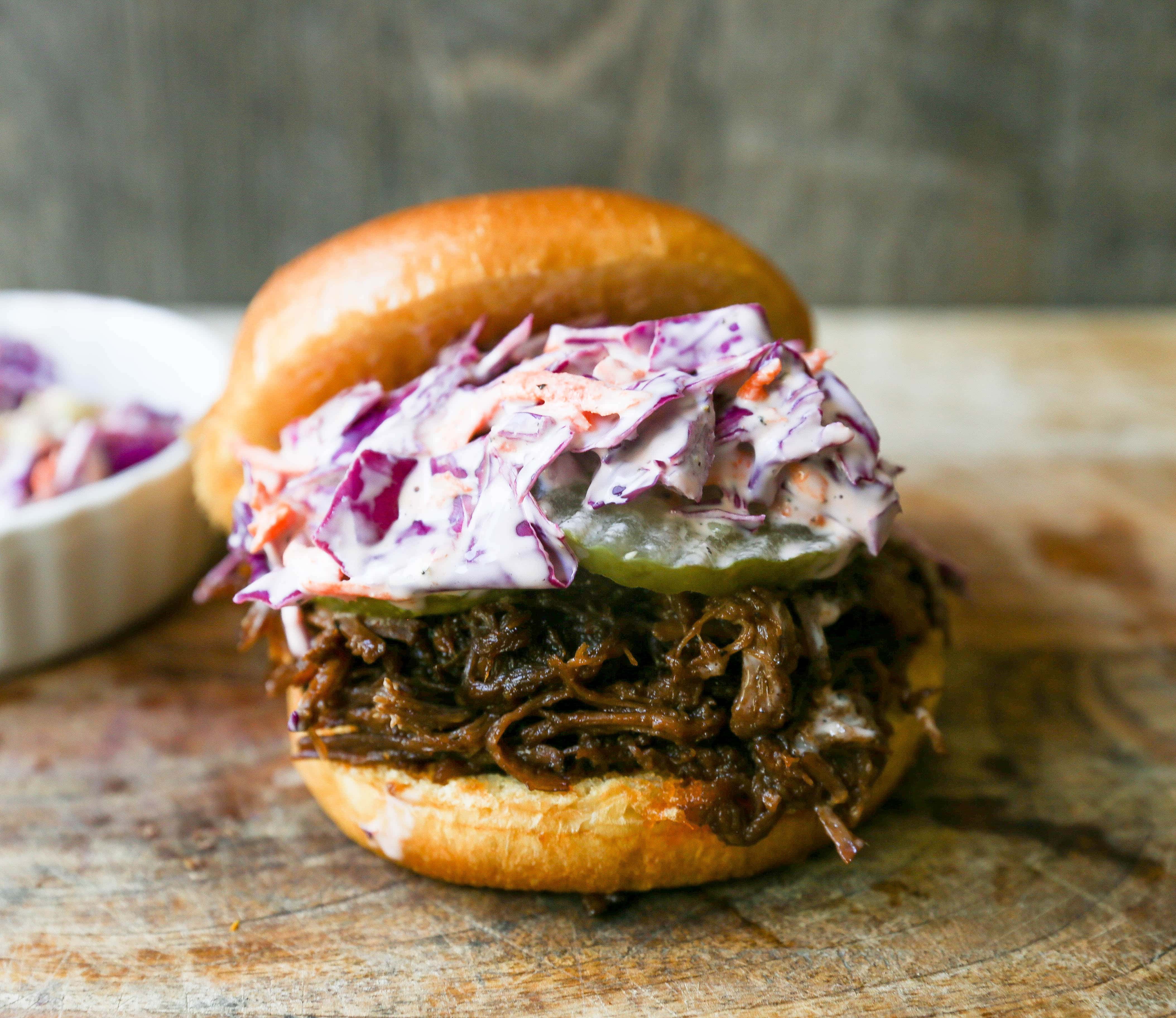 Slow Cooker BBQ Beef Sandwiches Tender seasoned slow cooked beef basted in BBQ sauce and sandwiched between brioche buns and topped with a crunchy coleslaw. www.modernhoney.com #bbqbeef #bbq #crockpot #slowcooker