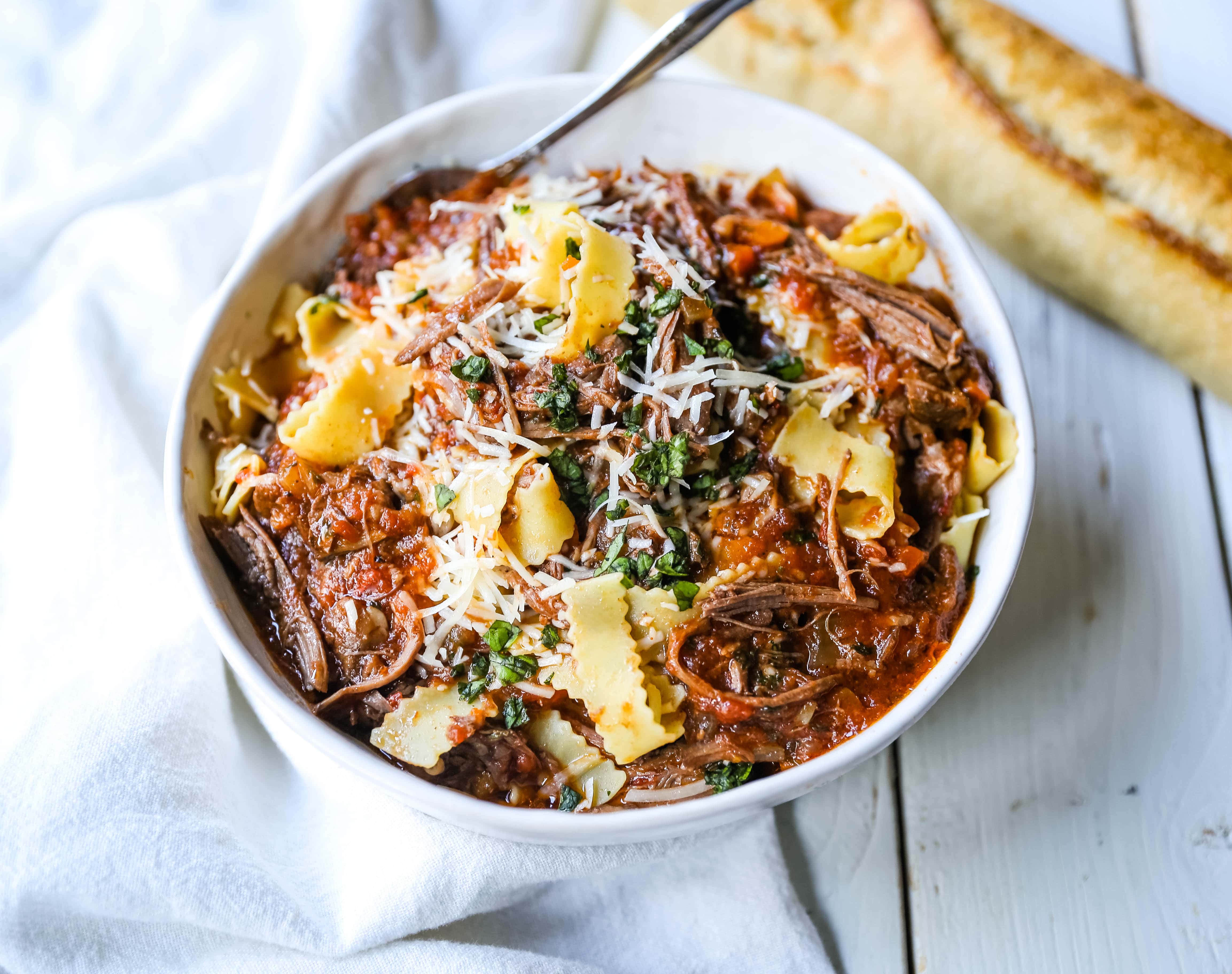 Sunday Slow Cooker Beef Ragu. Authentic Italian Beef Ragu. The ultimate comfort food! A big bowl of slow cooked, braised beef in a rich, robust tomato sauce tossed with pasta. I guarantee that you will go back for seconds! www.modernhoney.com #slowcooker #beefragu #italianfood #italian