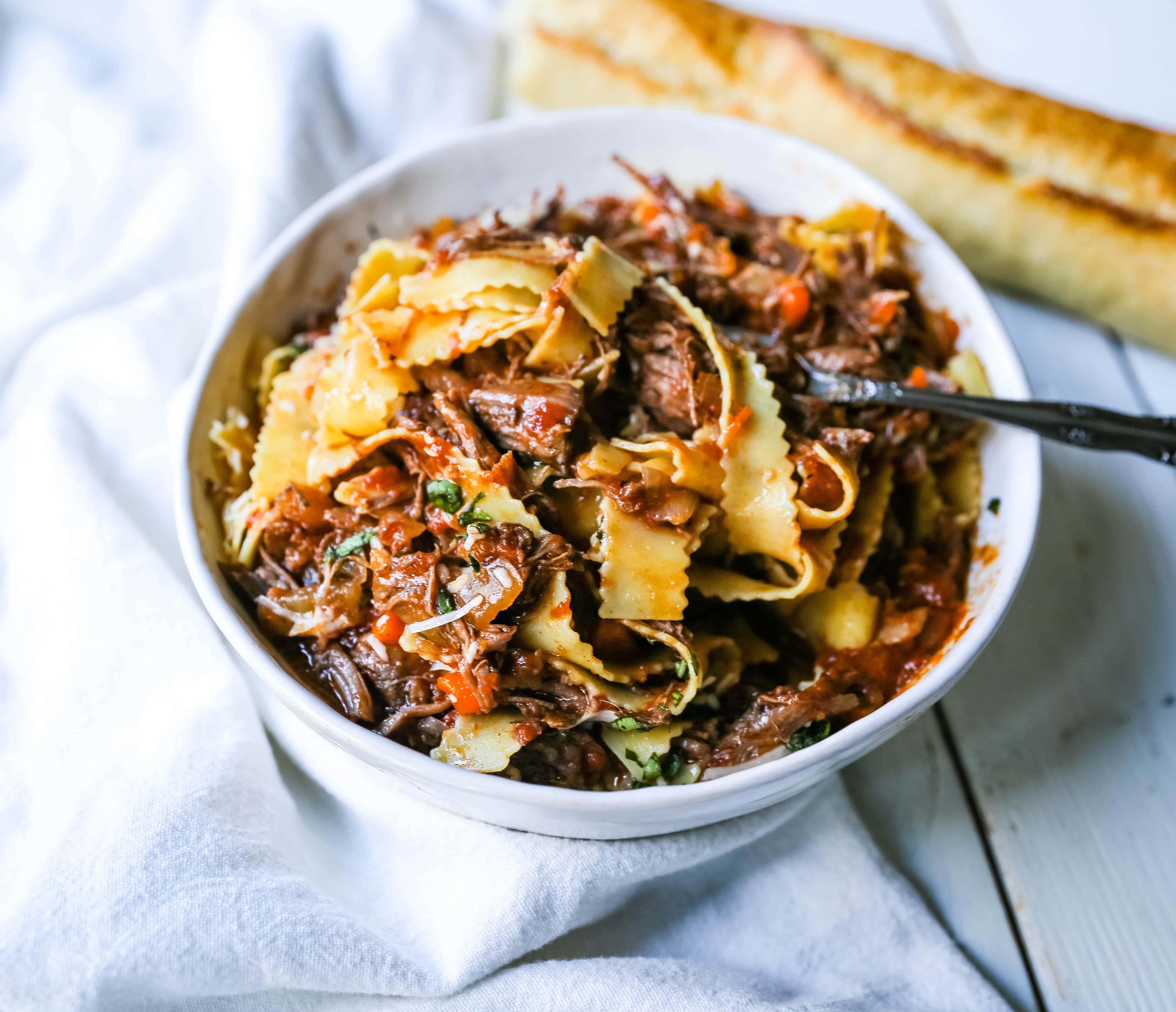 Sunday Slow Cooker Beef Ragu. Authentic Italian Beef Ragu. The ultimate comfort food! A big bowl of slow cooked, braised beef in a rich, robust tomato sauce tossed with pasta. I guarantee that you will go back for seconds! www.modernhoney.com #slowcooker #beefragu #italianfood #italian