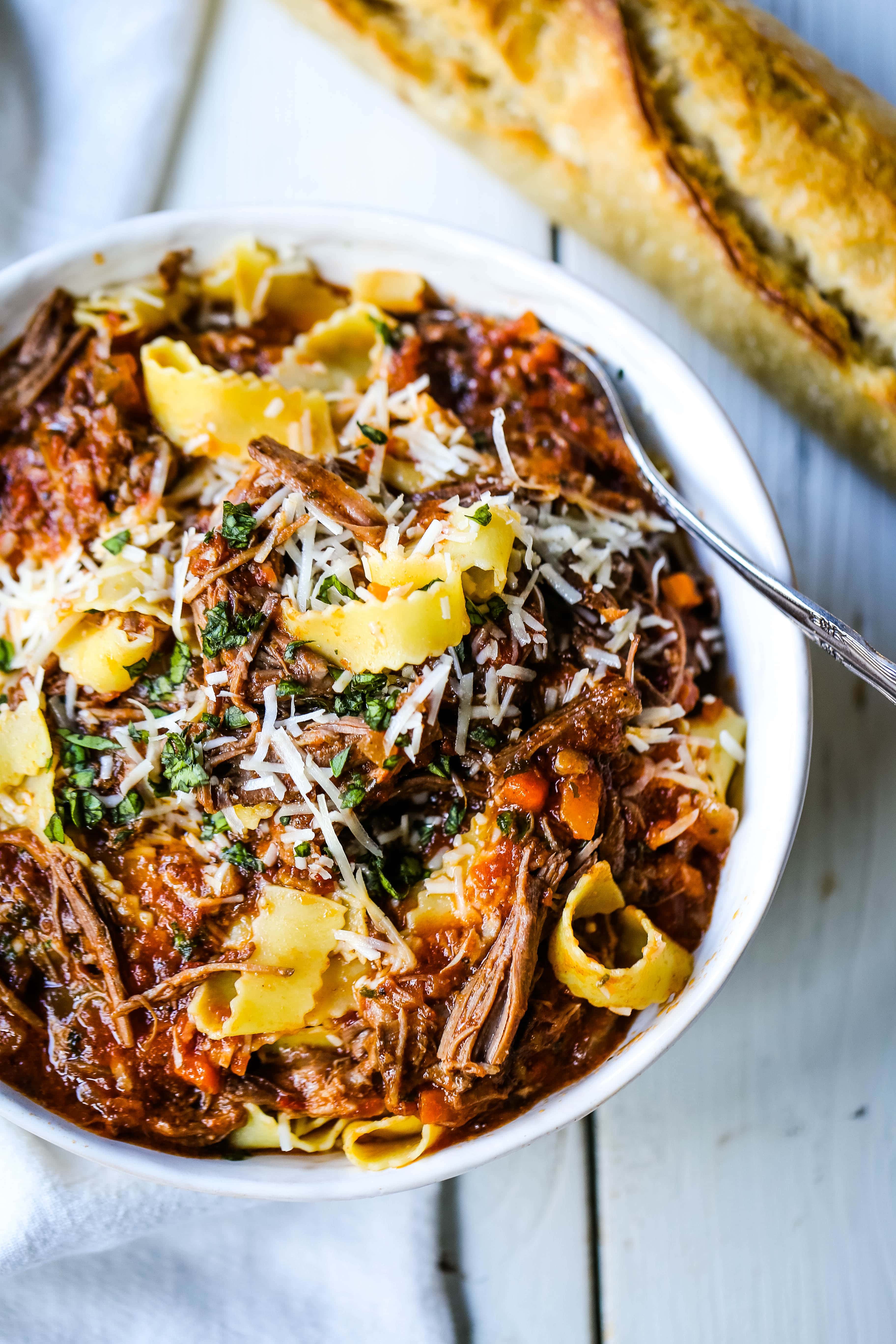 Sunday Slow Cooker Beef Ragu. Authentic Italian Beef Ragu. The ultimate comfort food! A big bowl of slow cooked, braised beef in a rich, robust tomato sauce tossed with pasta. I guarantee that you will go back for seconds! www.modernhoney.com #slowcooker #beefragu #italianfood #italian