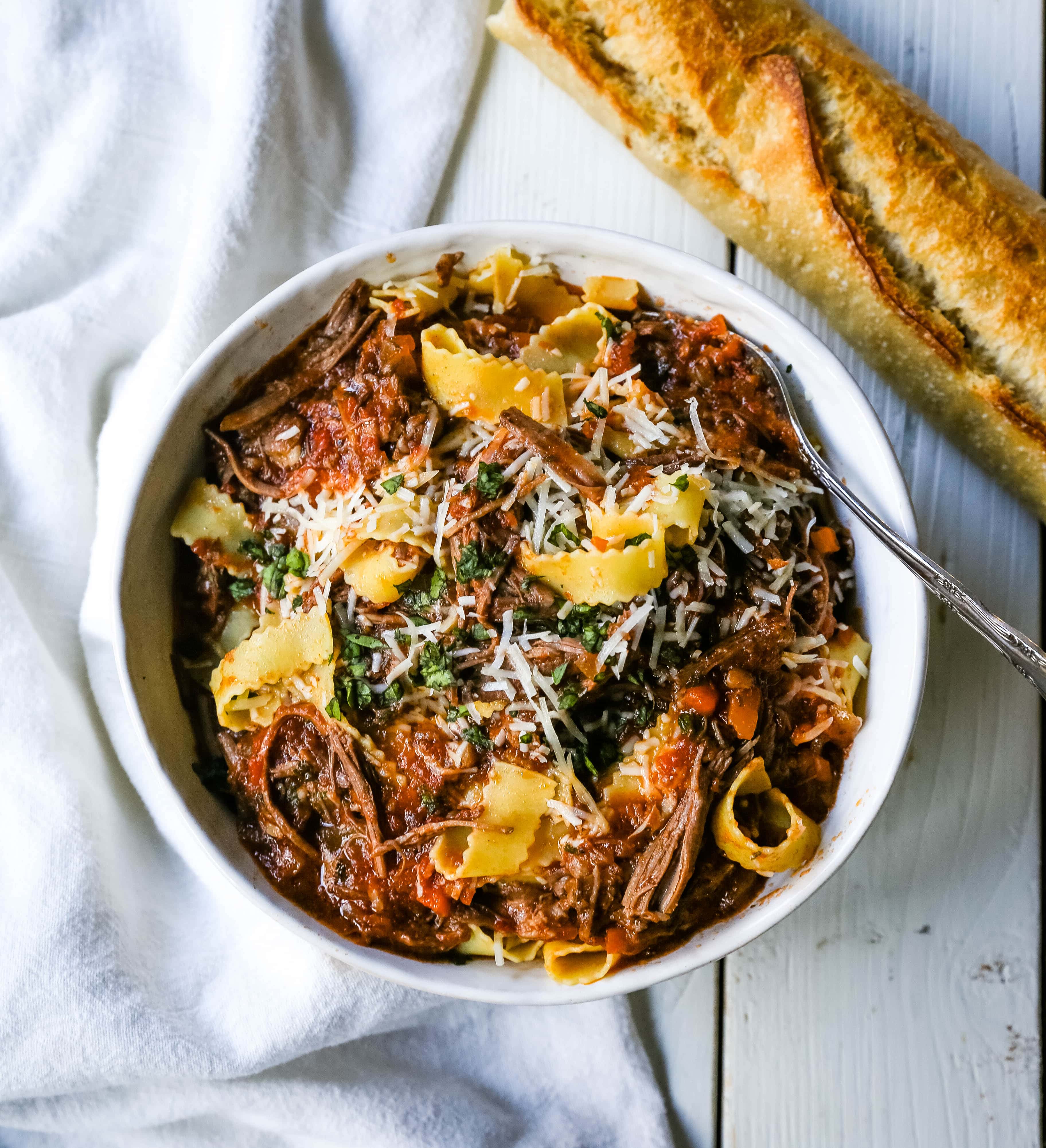 Sunday Slow Cooker Beef Ragu. Authentic Italian Beef Ragu. The ultimate comfort food! A big bowl of slow cooked, braised beef in a rich, robust tomato sauce tossed with pasta. I guarantee that you will go back for seconds! www.modernhoney.com #slowcooker #beefragu #italianfood #italian
