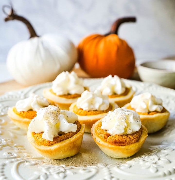 Mini Pumpkin Pie Bites. The best bite-size mini pumpkin pies perfect for entertaining during the holiday season. Creamy pumpkin pie filling in buttery pie crust cups topped with fresh whipped cream.  www.modernhoney.com #pumpkinpie #pumpkinpiebites #minipumpkinpies