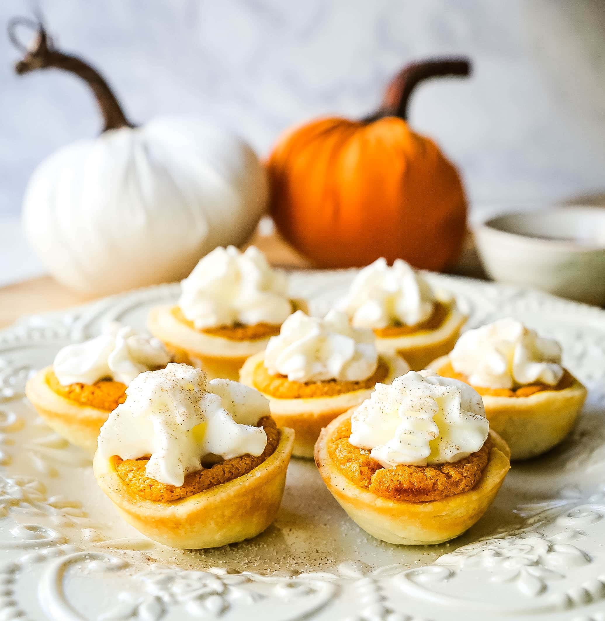 Mini Pumpkin Pie Bites. The best bite-size mini pumpkin pies perfect for entertaining during the holiday season. Creamy pumpkin pie filling in buttery pie crust cups topped with fresh whipped cream.  www.modernhoney.com #pumpkinpie #pumpkinpiebites #minipumpkinpies 