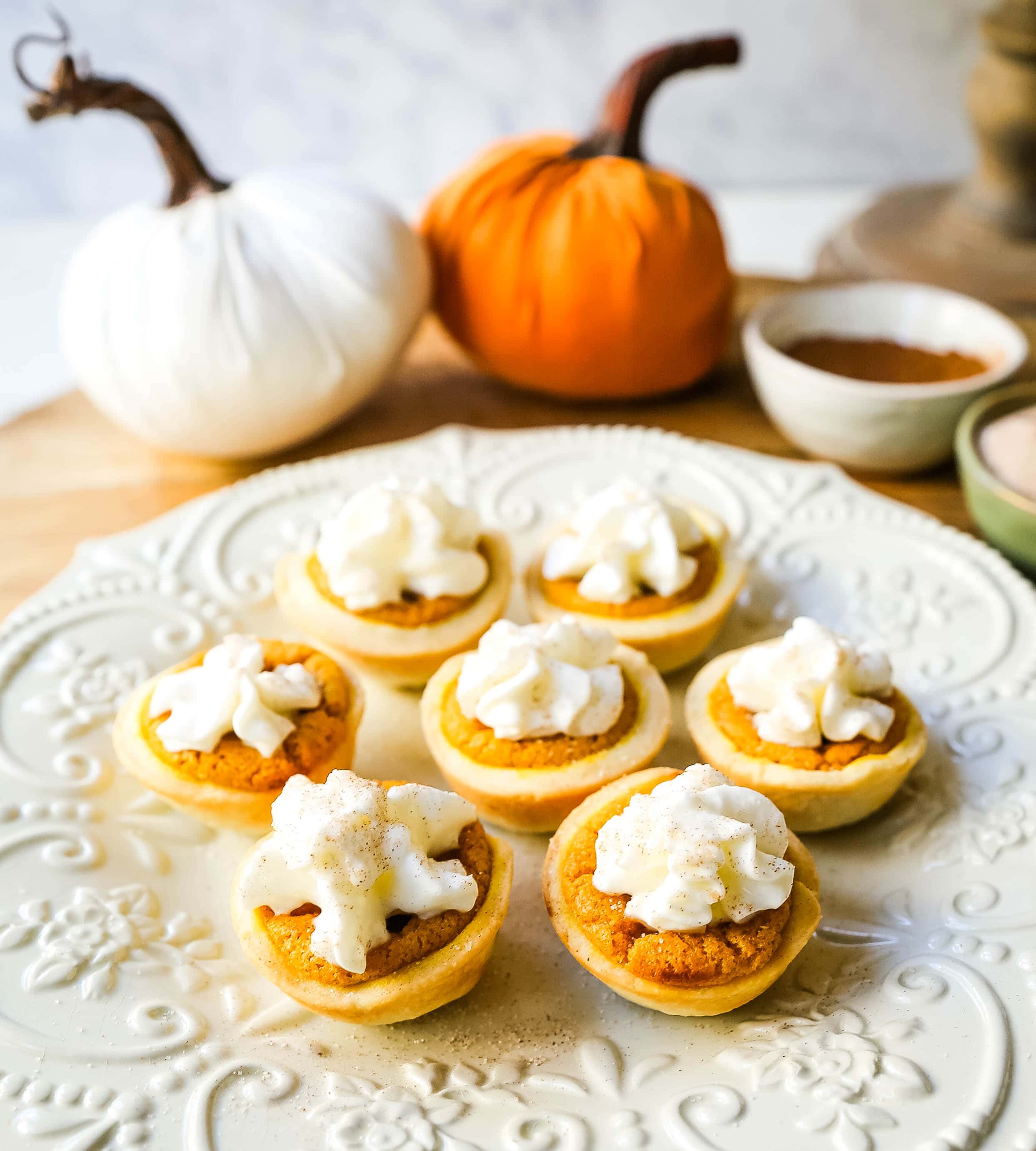 Mini Pumpkin Pie Bites. The best bite-size mini pumpkin pies perfect for entertaining during the holiday season. Creamy pumpkin pie filling in buttery pie crust cups topped with fresh whipped cream.  www.modernhoney.com #pumpkinpie #pumpkinpiebites #minipumpkinpies