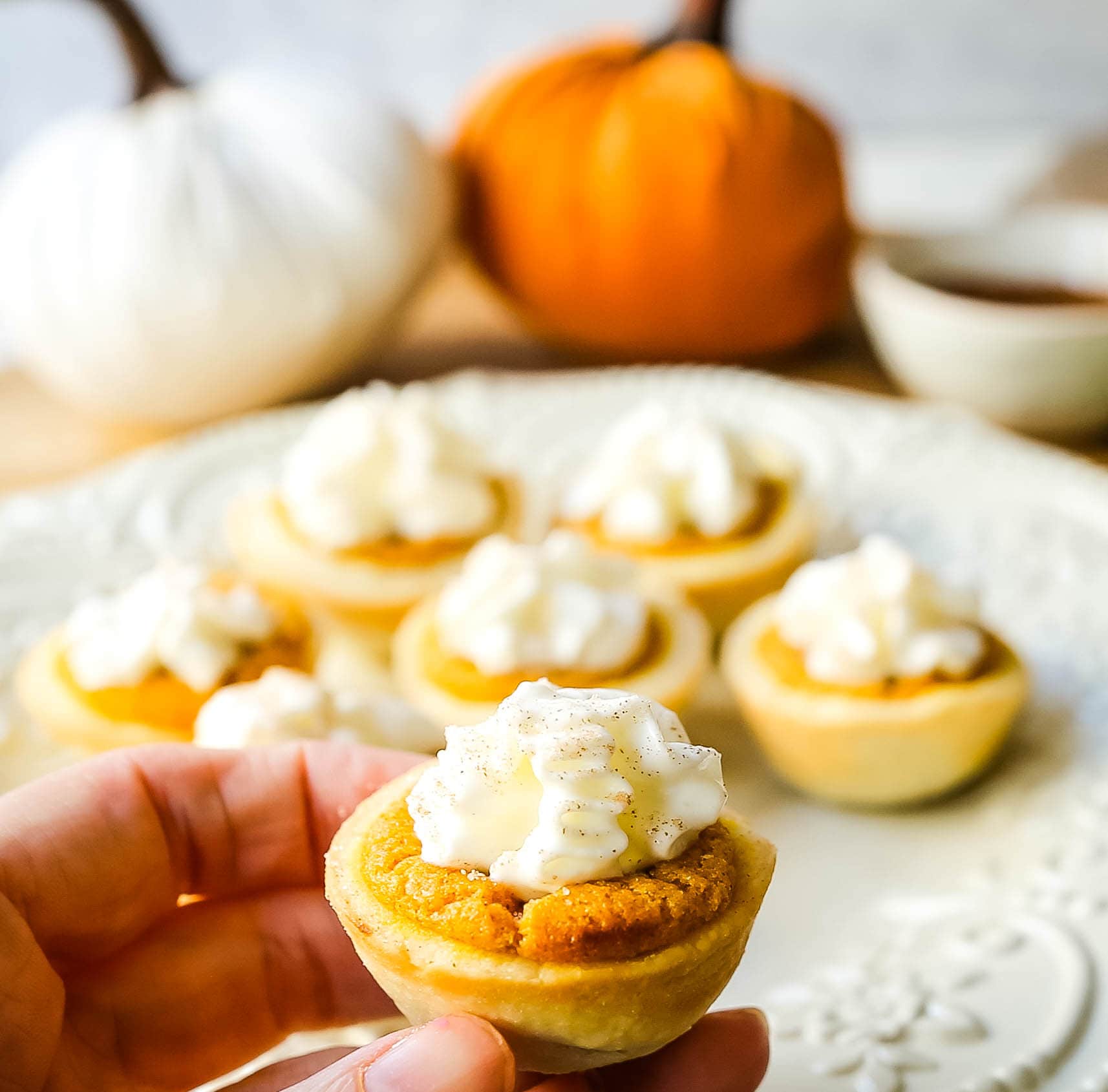 Mini Pumpkin Pie Bites. The best bite-size mini pumpkin pies perfect for entertaining during the holiday season. Creamy pumpkin pie filling in buttery pie crust cups topped with fresh whipped cream.  www.modernhoney.com #pumpkinpie #pumpkinpiebites #minipumpkinpies