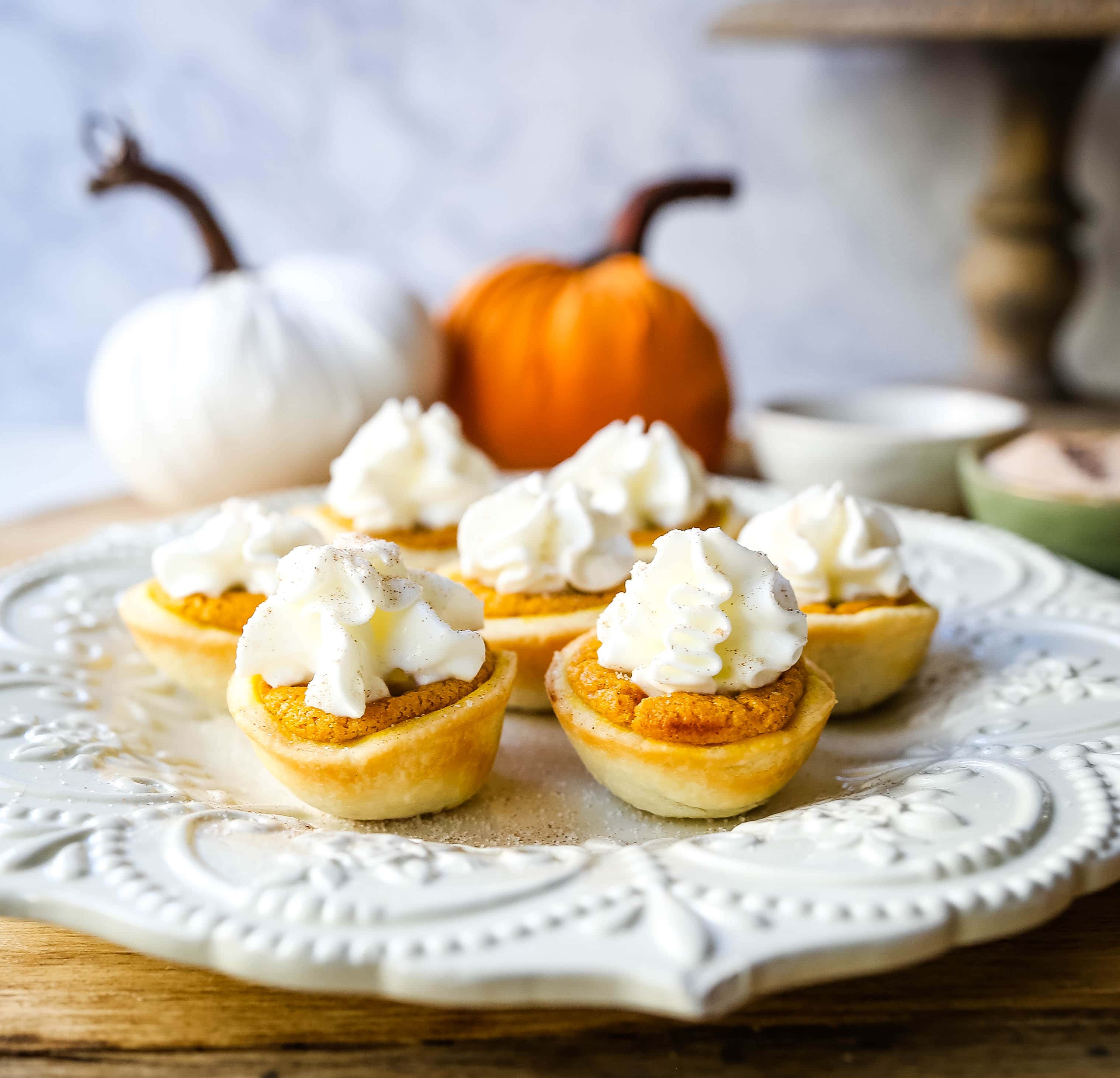 Mini Pumpkin Pie Bites. The best bite-size mini pumpkin pies perfect for entertaining during the holiday season. Creamy pumpkin pie filling in buttery pie crust cups topped with fresh whipped cream.  www.modernhoney.com #pumpkinpie #pumpkinpiebites #minipumpkinpies