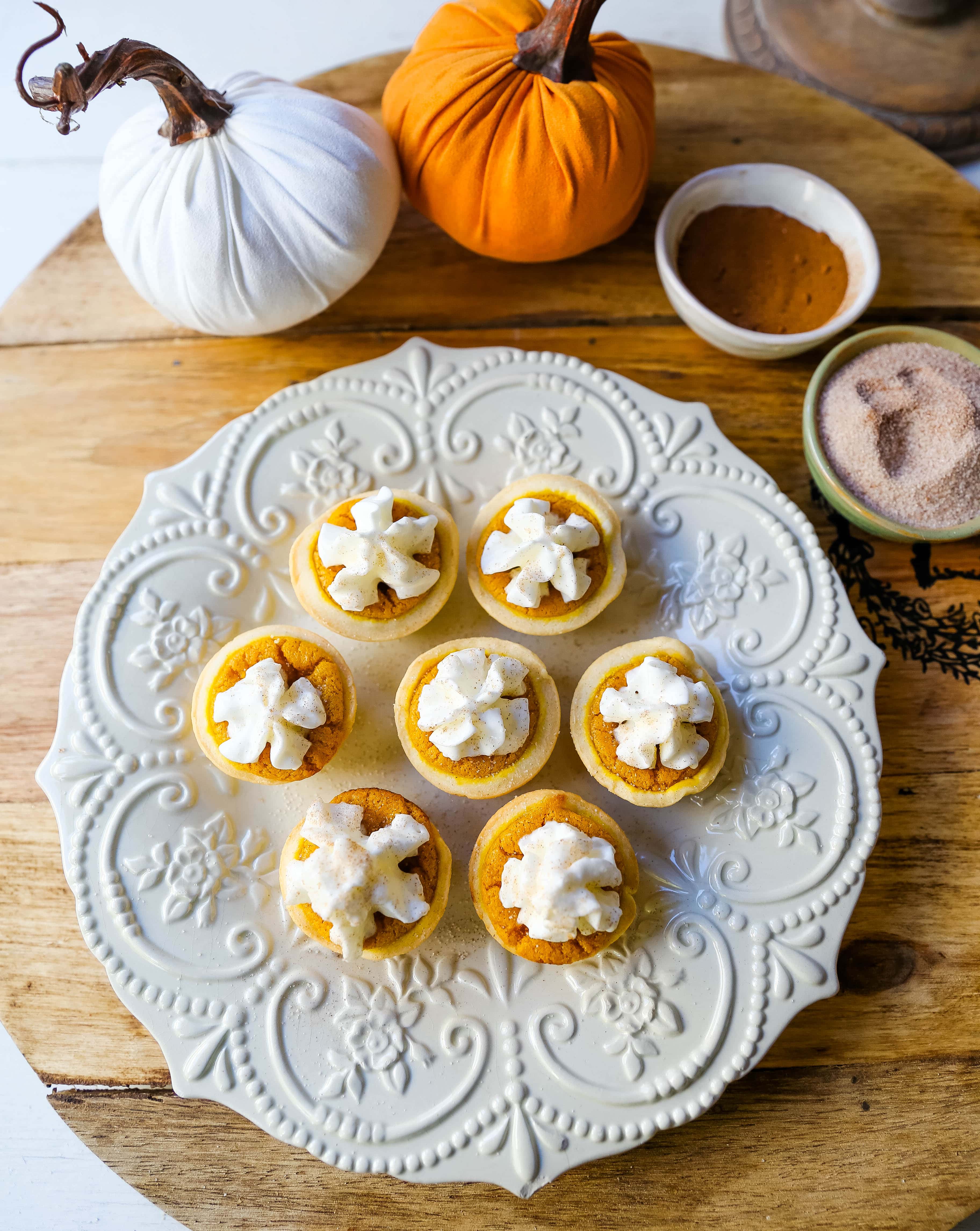 Mini Pumpkin Pie Bites. The best bite-size mini pumpkin pies perfect for entertaining during the holiday season. Creamy pumpkin pie filling in buttery pie crust cups topped with fresh whipped cream.  www.modernhoney.com #pumpkinpie #pumpkinpiebites #minipumpkinpies