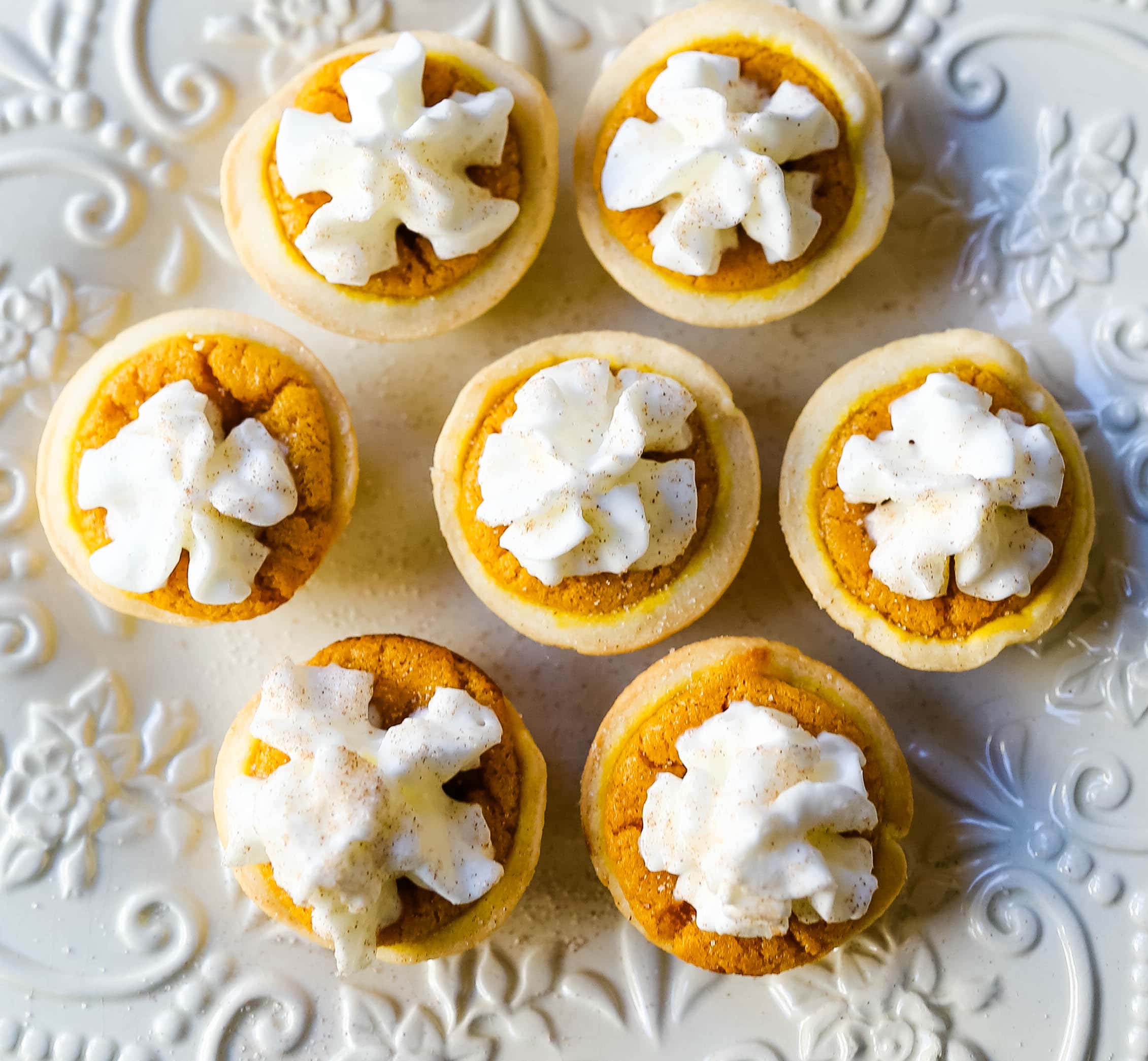 Mini Pumpkin Pie Bites. The best bite-size mini pumpkin pies perfect for entertaining during the holiday season. Creamy pumpkin pie filling in buttery pie crust cups topped with fresh whipped cream.  www.modernhoney.com #pumpkinpie #pumpkinpiebites #minipumpkinpies