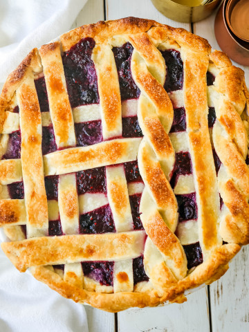 Triple Berry Pie. The best homemade berry pie recipe with a buttery pie crust. Top it with vanilla bean ice cream and you have the perfect berry dessert! The best berry pie recipe. www.modernhoney.com #berrypie #pie #berries #tripleberrypie #thanksgiving