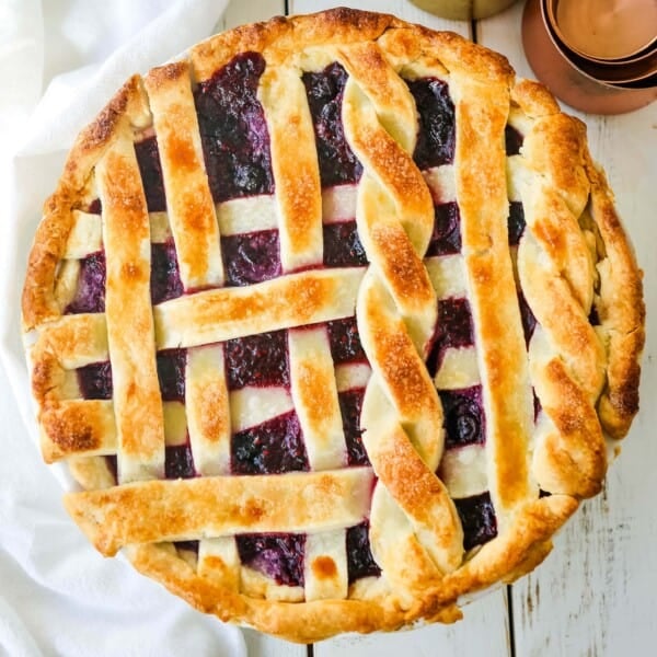 Triple Berry Pie. The best homemade berry pie recipe with a buttery pie crust. Top it with vanilla bean ice cream and you have the perfect berry dessert! The best berry pie recipe. www.modernhoney.com #berrypie #pie #berries #tripleberrypie #thanksgiving