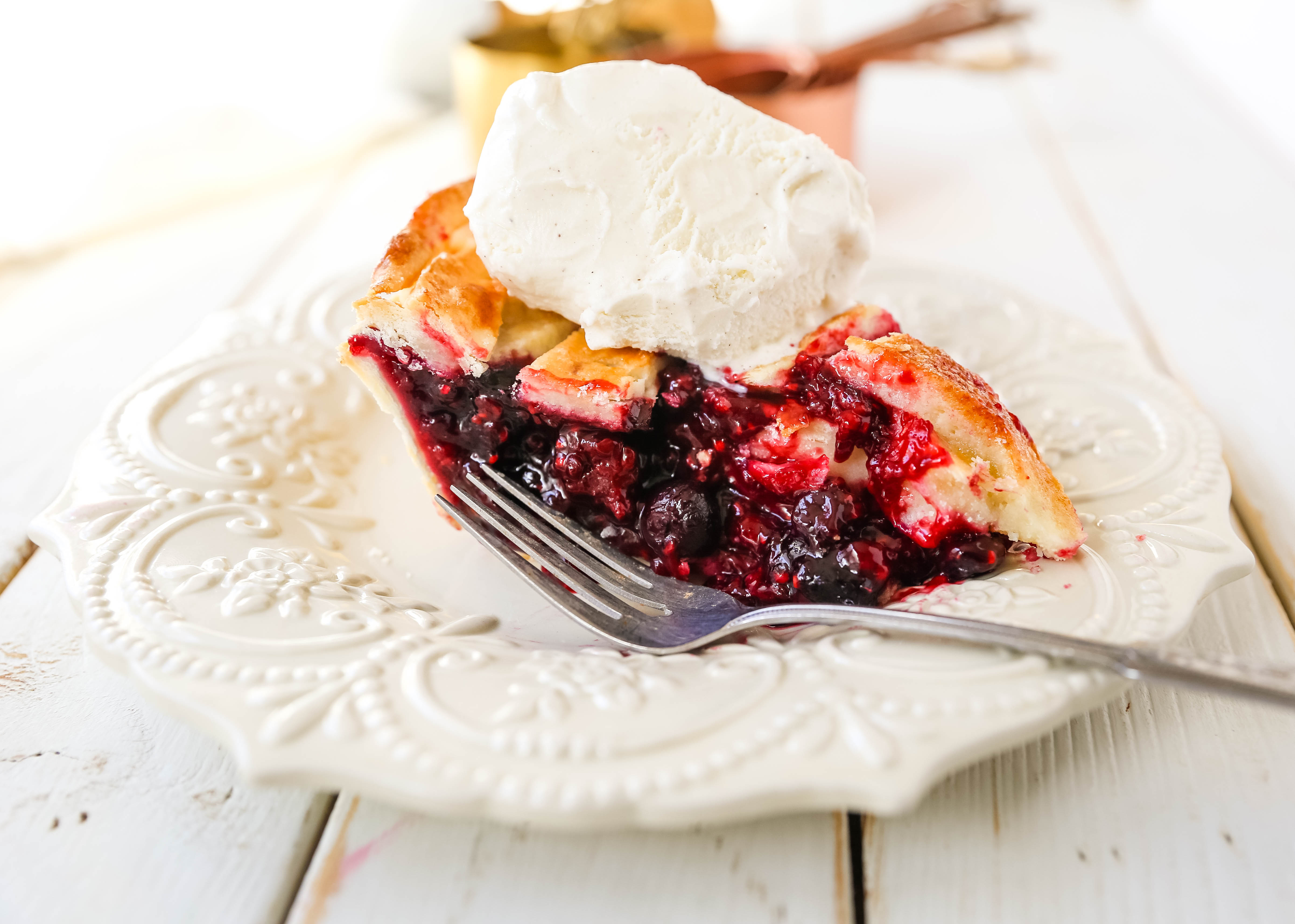 Triple Berry Pie. The best homemade berry pie recipe with a buttery pie crust. Top it with vanilla bean ice cream and you have the perfect berry dessert! The best berry pie recipe. www.modernhoney.com #berrypie #pie #berries #tripleberrypie #thanksgiving