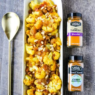 Turmeric Roasted Cauliflower Indian spiced roasted cauliflower with warm spices, caramelized onions, sweet golden raisins, and crunchy pine nuts. A flavorful, healthy side dish perfect for any occasion! www.modernhoney.com #cauliflower #sidedish #roastedvegetables #indianfood