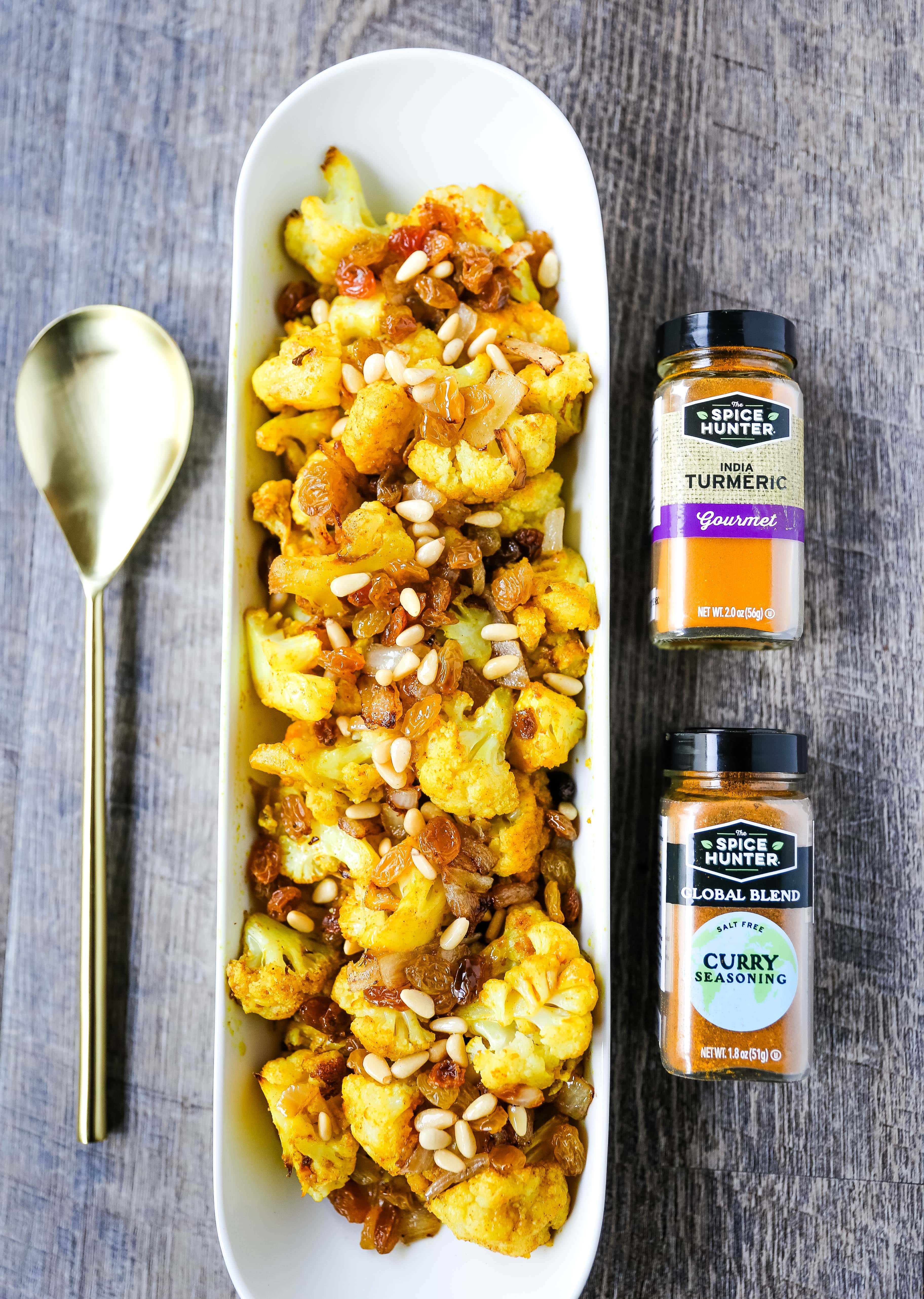 Turmeric Roasted Cauliflower Indian spiced roasted cauliflower with warm spices, caramelized onions, sweet golden raisins, and crunchy pine nuts. A flavorful, healthy side dish perfect for any occasion! www.modernhoney.com #cauliflower #sidedish #roastedvegetables #indianfood 