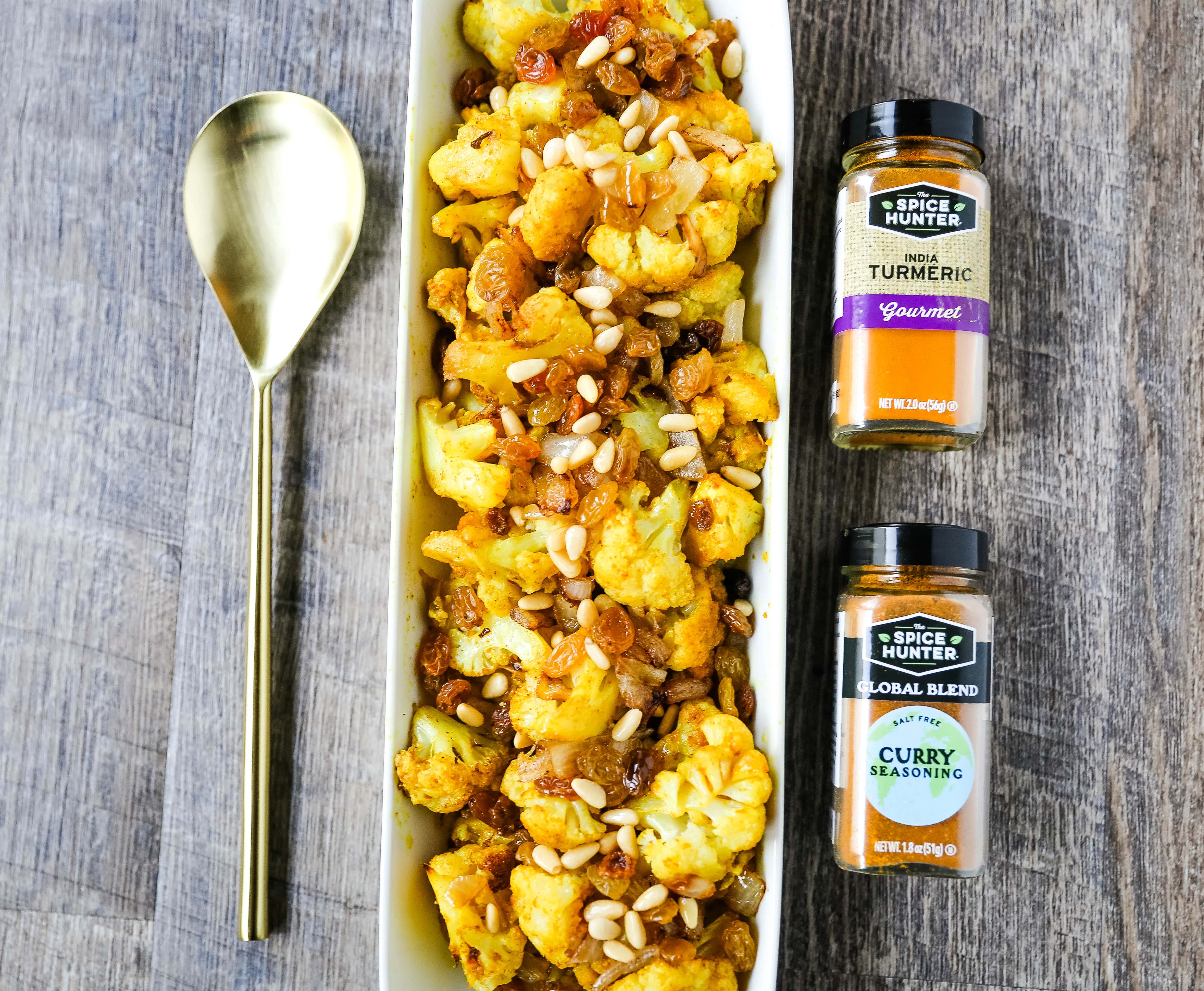 Turmeric Roasted Cauliflower Indian spiced roasted cauliflower with warm spices, caramelized onions, sweet golden raisins, and crunchy pine nuts. A flavorful, healthy side dish perfect for any occasion! www.modernhoney.com #cauliflower #sidedish #roastedvegetables #indianfood 