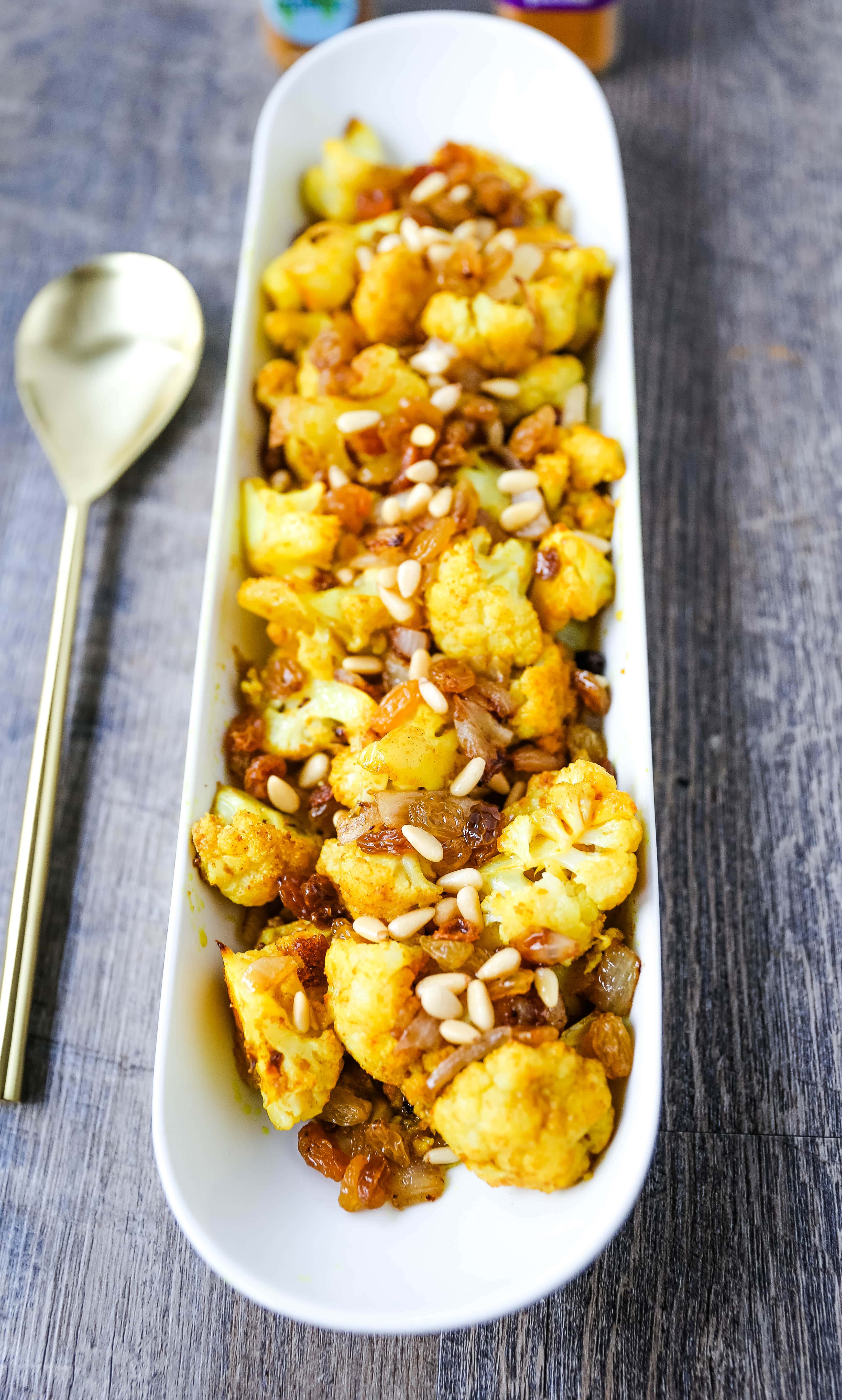 Turmeric Roasted Cauliflower Indian spiced roasted cauliflower with warm spices, caramelized onions, sweet golden raisins, and crunchy pine nuts. A flavorful, healthy side dish perfect for any occasion! www.modernhoney.com #cauliflower #sidedish #roastedvegetables #indianfood 