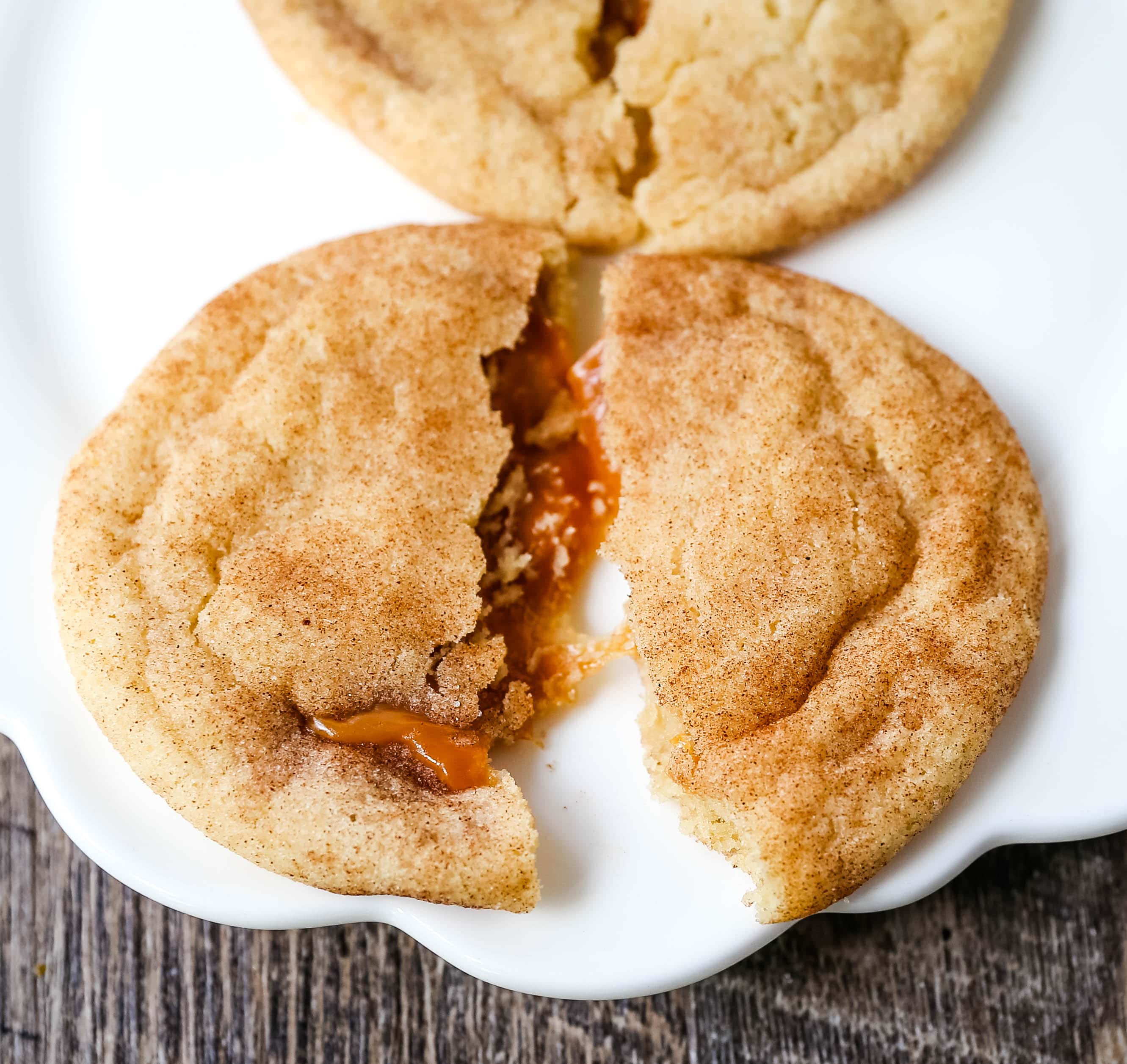 Caramel Filled Snickerdoodle Cookies Soft chewy cinnamon sugar snickerdoodle cookies stuffed with buttery caramel. The perfect caramel stuffed snickerdoodle cookie recipe! www.modernhoney.com #caramelsnickerdoodles #christmascookies #cookie #cookies