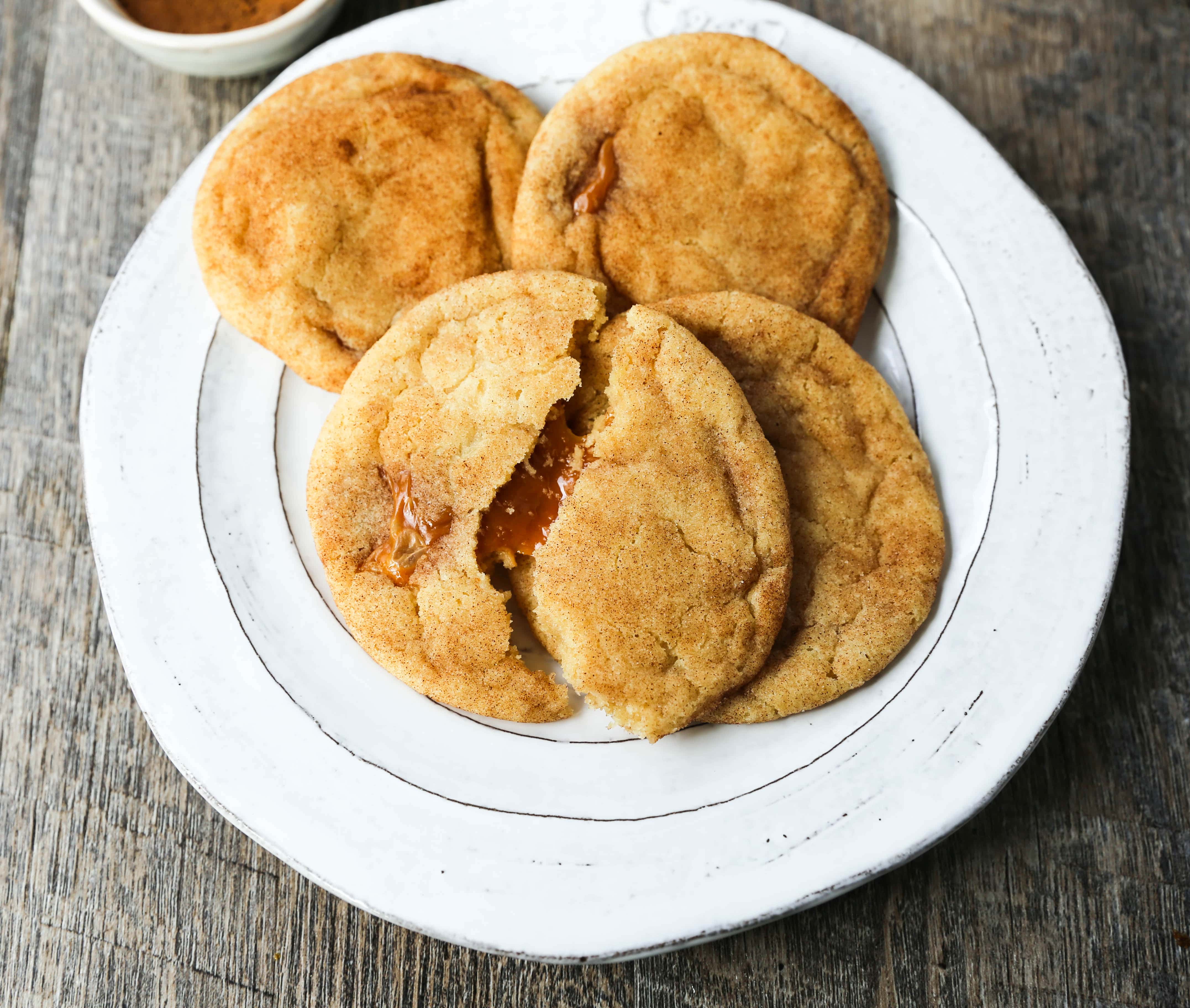 Caramel Filled Snickerdoodle Cookies Soft chewy cinnamon sugar snickerdoodle cookies stuffed with buttery caramel. The perfect caramel stuffed snickerdoodle cookie recipe! www.modernhoney.com #caramelsnickerdoodles #christmascookies #cookie #cookies