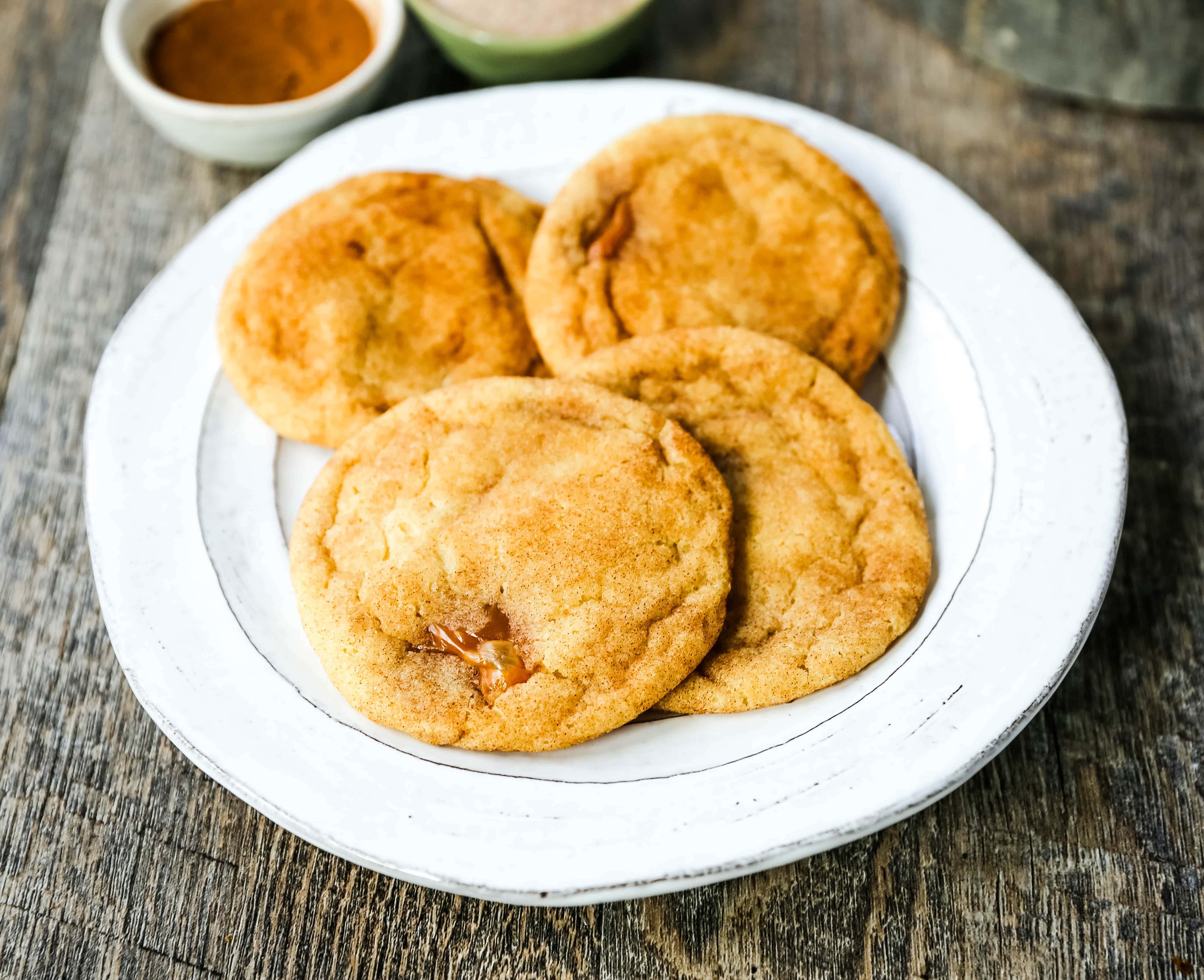 Caramel Filled Snickerdoodle Cookies Soft chewy cinnamon sugar snickerdoodle cookies stuffed with buttery caramel. The perfect caramel stuffed snickerdoodle cookie recipe! www.modernhoney.com #caramelsnickerdoodles #christmascookies #cookie #cookies