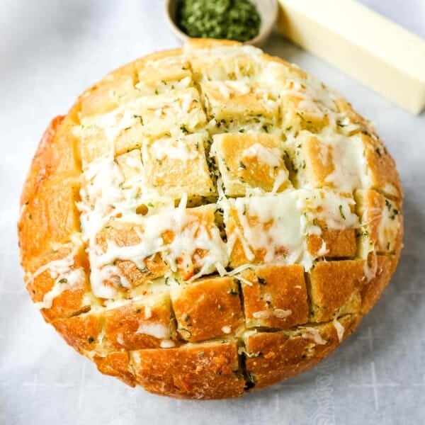 Cheesy Pull-Apart Garlic Bread Warm sourdough bread baked with garlic butter, melted mozzarella cheese, and spices. The best pull-apart garlic cheese bread! www.modernhoney.com #garlicbread #cheesebread #garliccheesebread