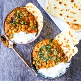 Coconut Chickpea Curry A rich coconut curry broth with onion, garlic, ginger, Indian spices in coconut milk and tossed with chickpeas. Flavorful vegan meal and you won't even miss the meat! www.modernhoney.com #vegan #curry #indianfood #vegancurry #chickpeacurry