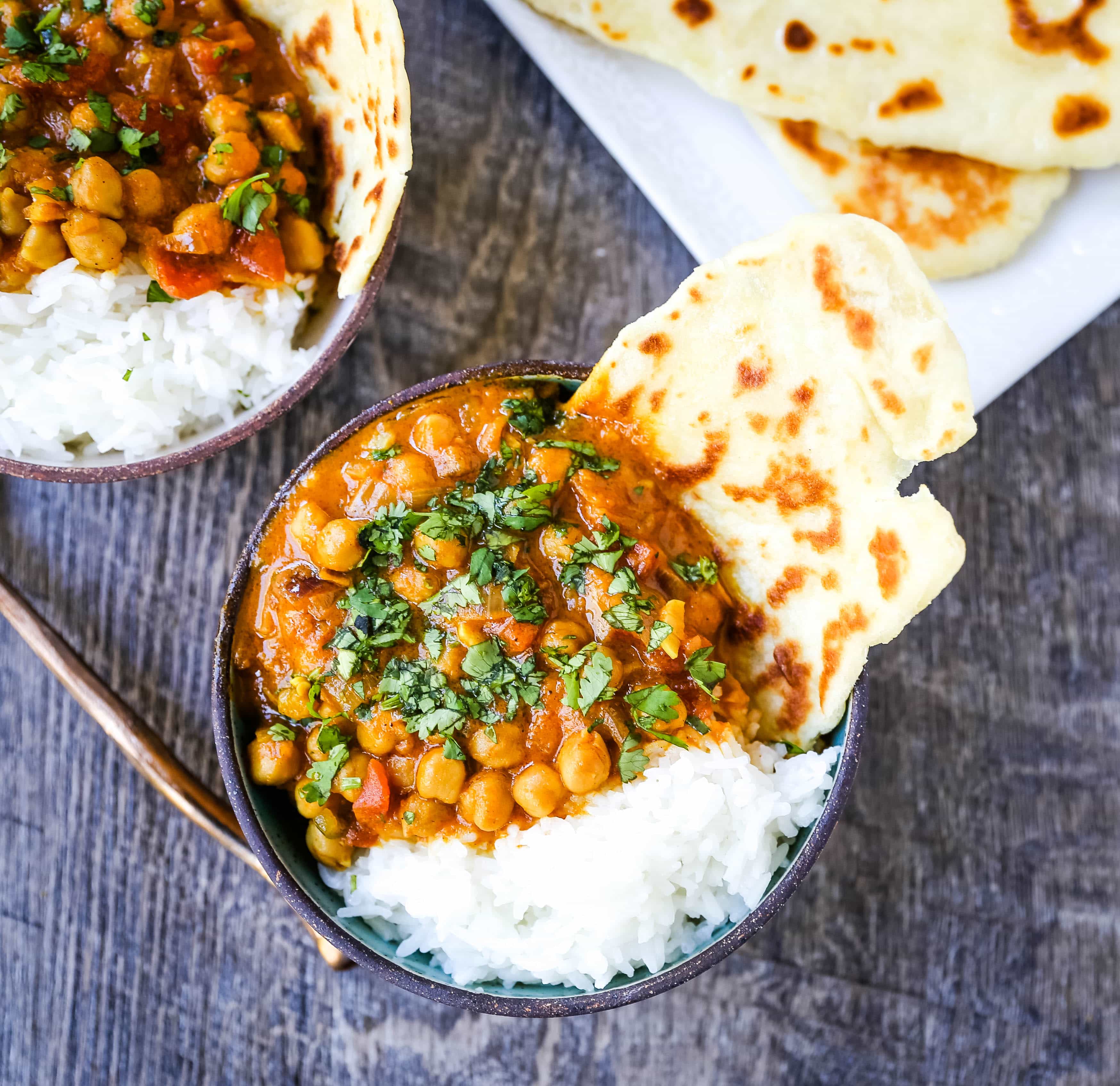 Coconut Chickpea Curry A rich coconut curry broth with onion, garlic, ginger, Indian spices in coconut milk and tossed with chickpeas. Flavorful vegan meal and you won't even miss the meat!  www.modernhoney.com #vegan #curry #indianfood #vegancurry #chickpeacurry