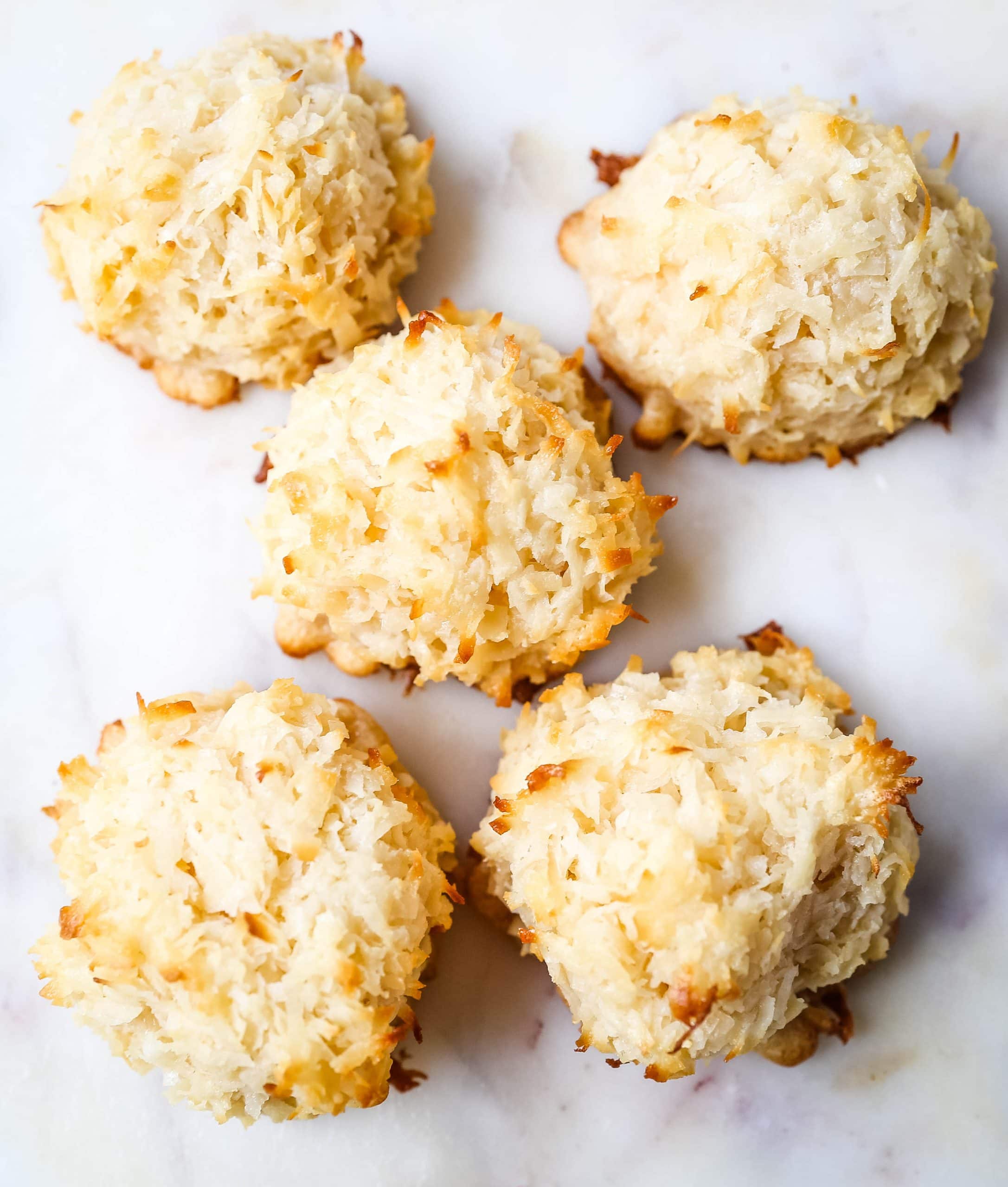 The Best Coconut Macaroons. Soft chewy sweet coconut macaroons are the perfect gluten-free cookie. How to make the perfect coconut macaroons dipped in dark chocolate. www.modernhoney.com #macaroons #coconutmacaroons #macaroon #christmascookie #christmascookies