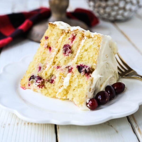 Cranberry Orange Cake. A moist orange zest cake with fresh cranberries with a sweet cream cheese orange frosting. A sweet yet tart holiday cake. www.modernhoney.com #cranberry #cranberrycake #cranberryorange #cranberryorangecake