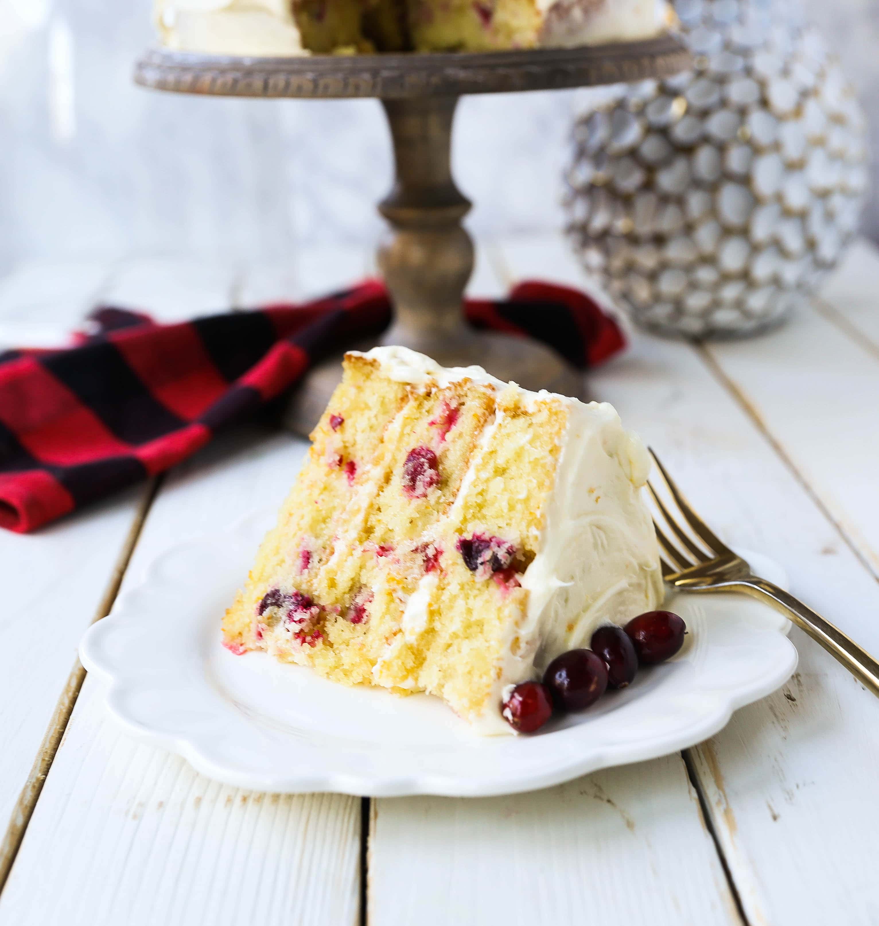 Cranberry Orange Cake. A moist orange zest cake with fresh cranberries with a sweet cream cheese orange frosting. A sweet yet tart holiday cake. www.modernhoney.com #cranberry #cranberrycake #cranberryorange #cranberryorangecake