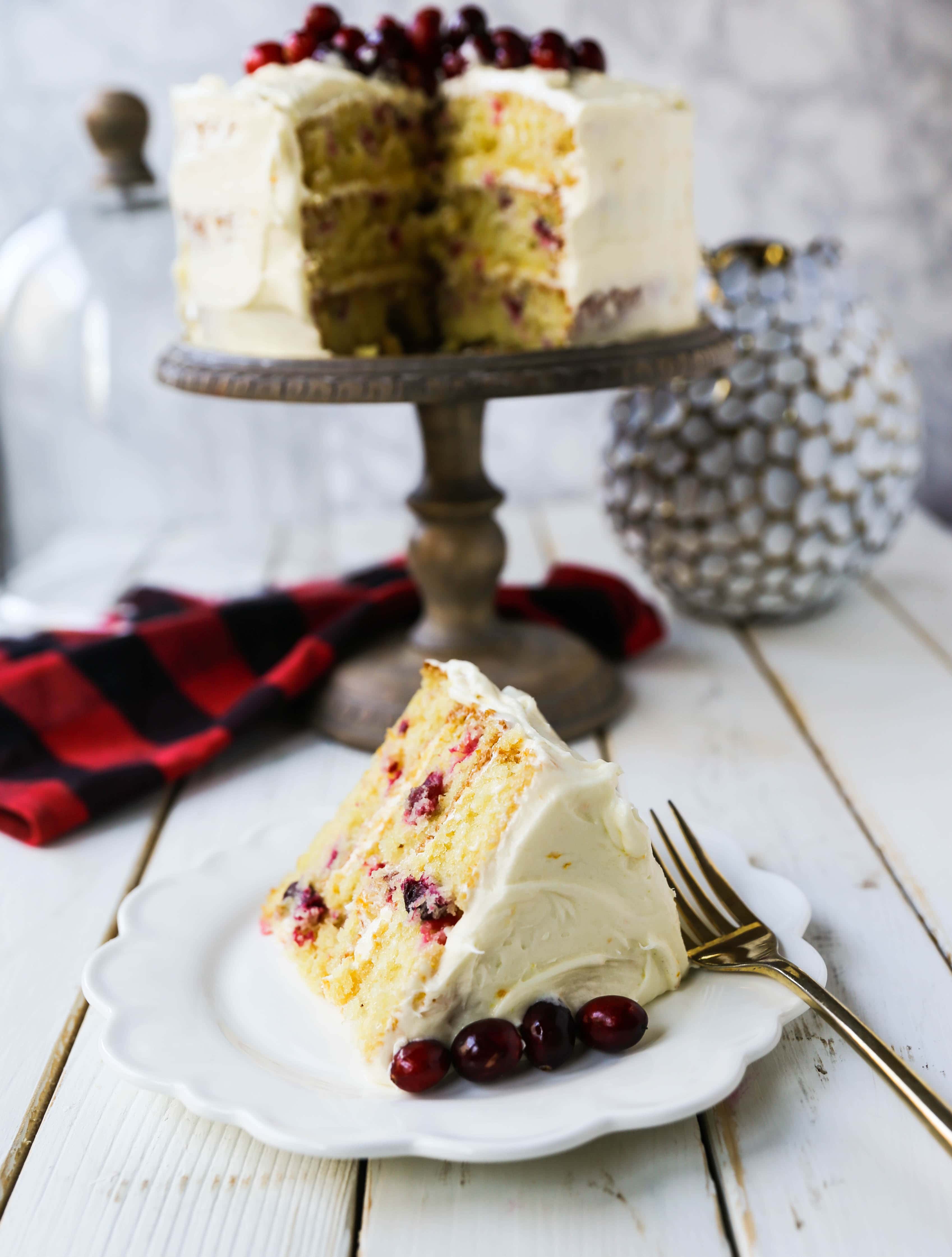 Cranberry Orange Cake. A moist orange zest cake with fresh cranberries with a sweet cream cheese orange frosting. A sweet yet tart holiday cake. www.modernhoney.com #cranberry #cranberrycake #cranberryorange #cranberryorangecake