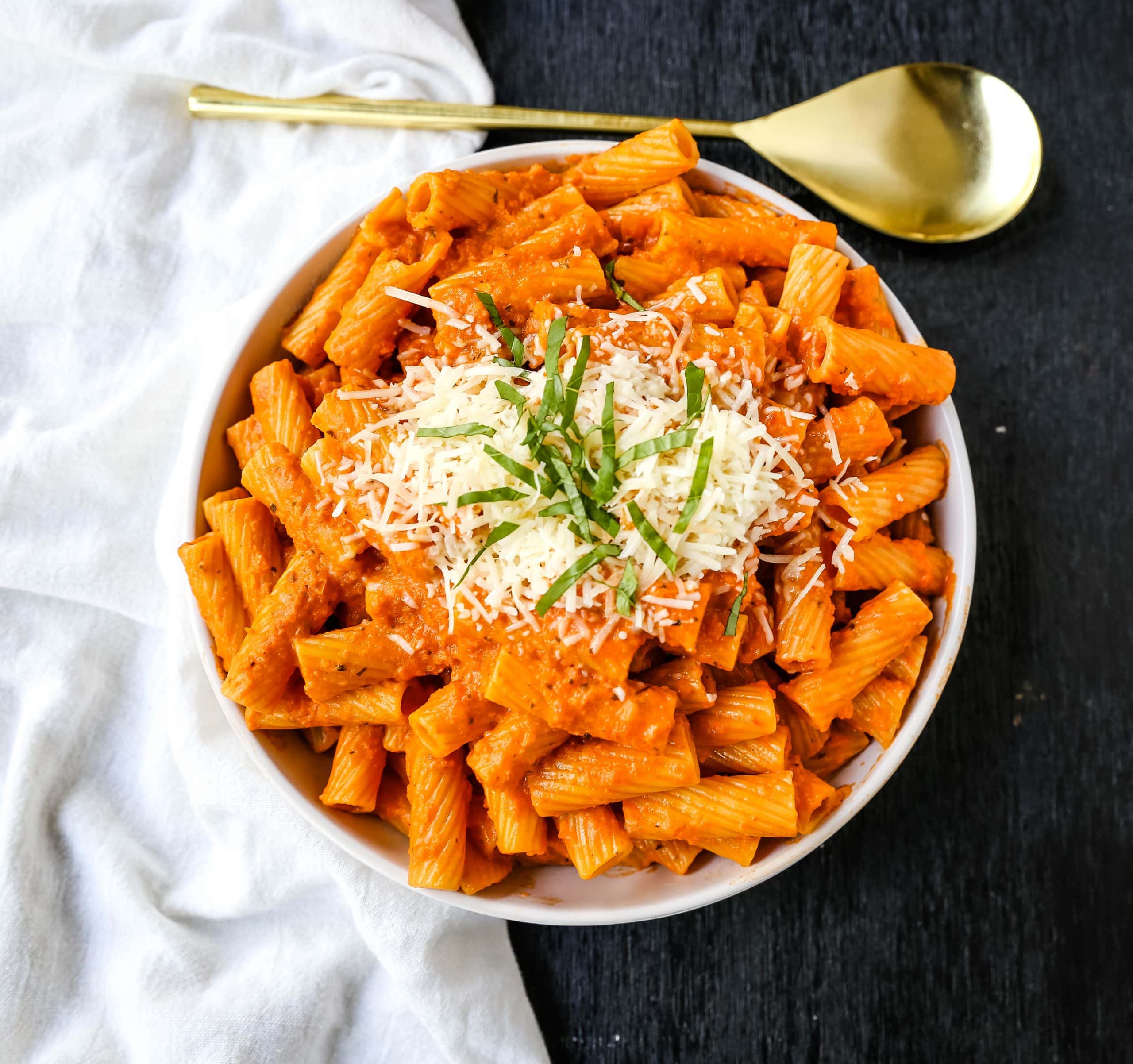 Creamy Roasted Red Pepper Pasta  A creamy roasted red pepper and tomato basil sauce with garlic and heavy cream all tossed together with pasta and topped with parmesan cheese. A flavorful robust pasta dish! www.modernhoney.com #pasta #italian #italianfood 