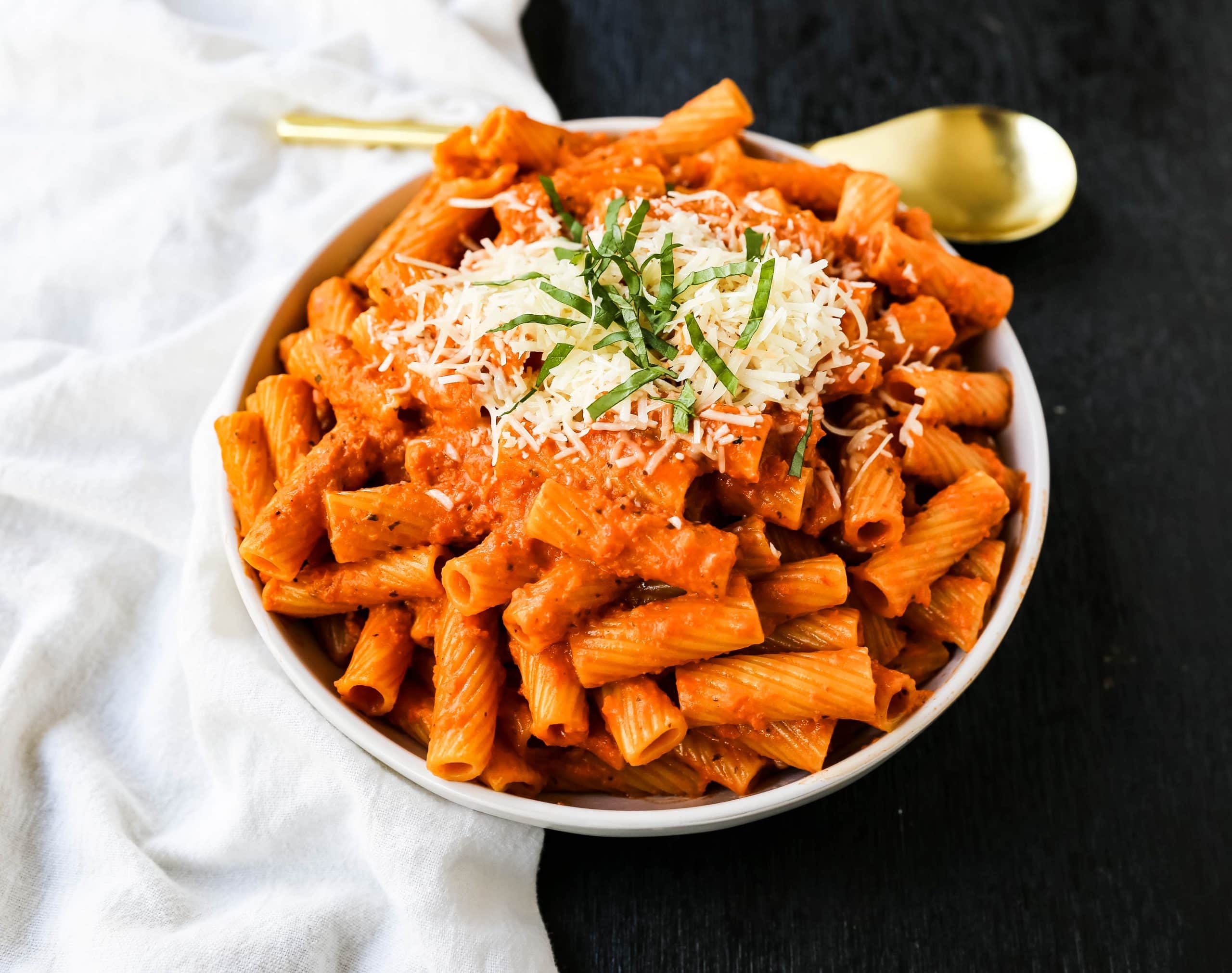 Creamy Roasted Red Pepper Pasta  A creamy roasted red pepper and tomato basil sauce with garlic and heavy cream all tossed together with pasta and topped with parmesan cheese. A flavorful robust pasta dish! www.modernhoney.com #pasta #italian #italianfood 