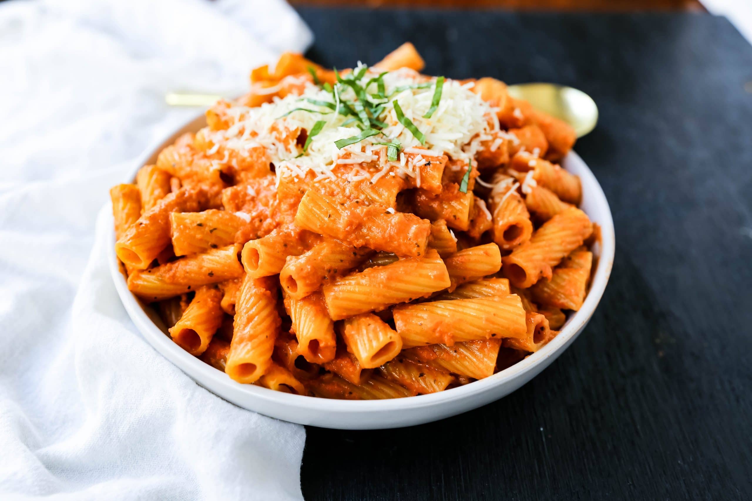 Creamy Roasted Red Pepper Pasta  A creamy roasted red pepper and tomato basil sauce with garlic and heavy cream all tossed together with pasta and topped with parmesan cheese. A flavorful robust pasta dish! www.modernhoney.com #pasta #italian #italianfood 