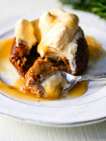 Sticky Toffee Pudding A famous English dessert with a moist sponge cake covered in a homemade caramel toffee sauce and vanilla ice cream. The perfect Christmas dessert or holiday dessert recipe. A Christmas traditional dessert. www.modernhoney.com #stickytoffeepudding #toffeepudding #stickypudding #datecake