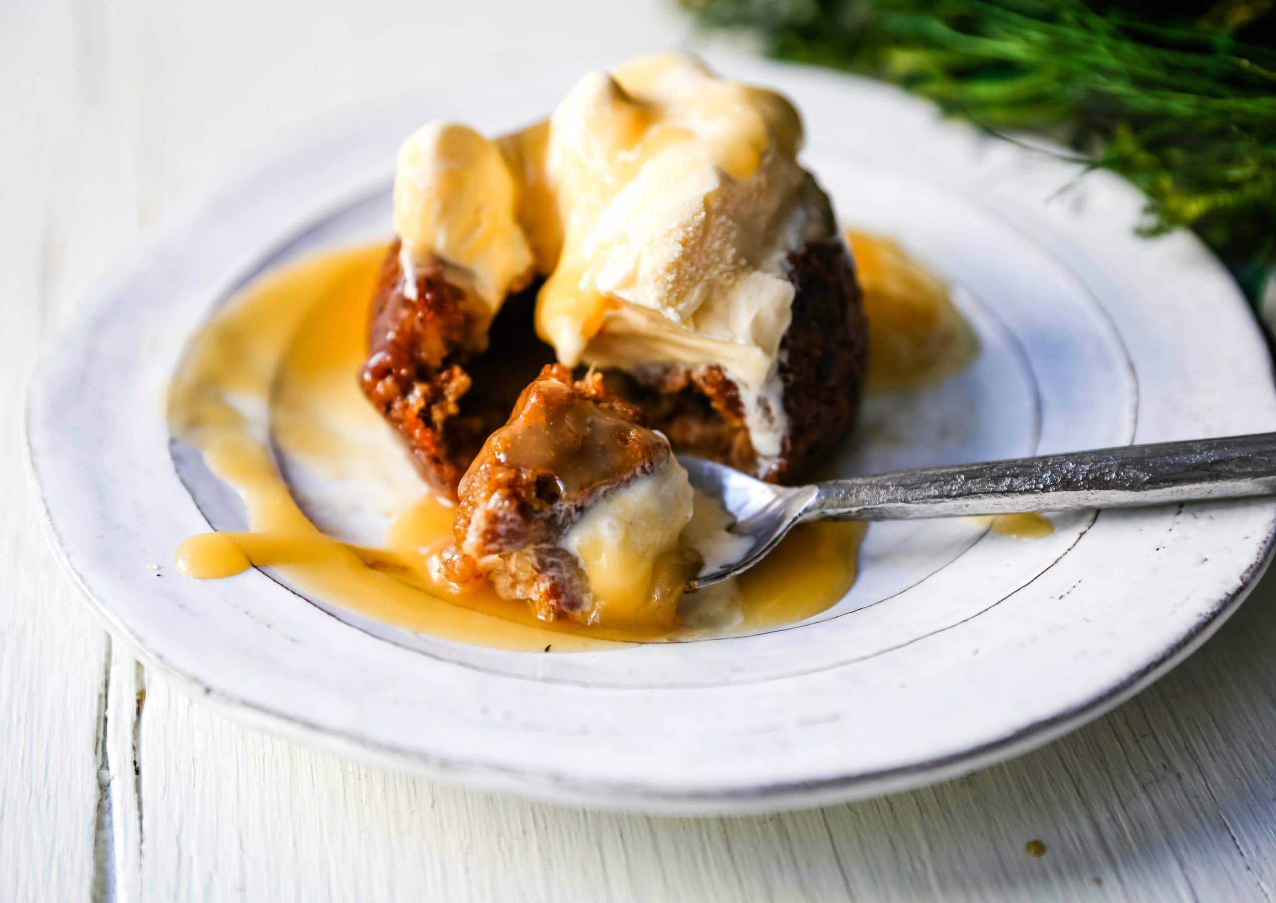 Sticky Toffee Pudding A famous English dessert with a moist sponge cake covered in a homemade caramel toffee sauce and vanilla ice cream. The perfect Christmas dessert or holiday dessert recipe. A Christmas traditional dessert. www.modernhoney.com #stickytoffeepudding #toffeepudding #stickypudding #datecake