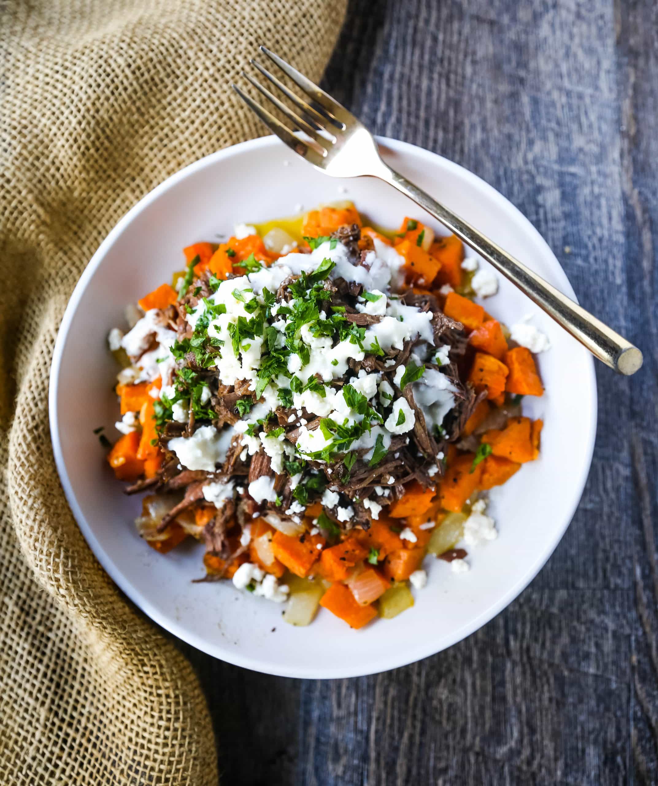 Braised Beef and Sweet Potato Hash Bowl. Tender braised beef on top of a sweet potato onion hash and topped with feta cheese and herbs. www.modernhoney.com #bowl #bowls #dinner