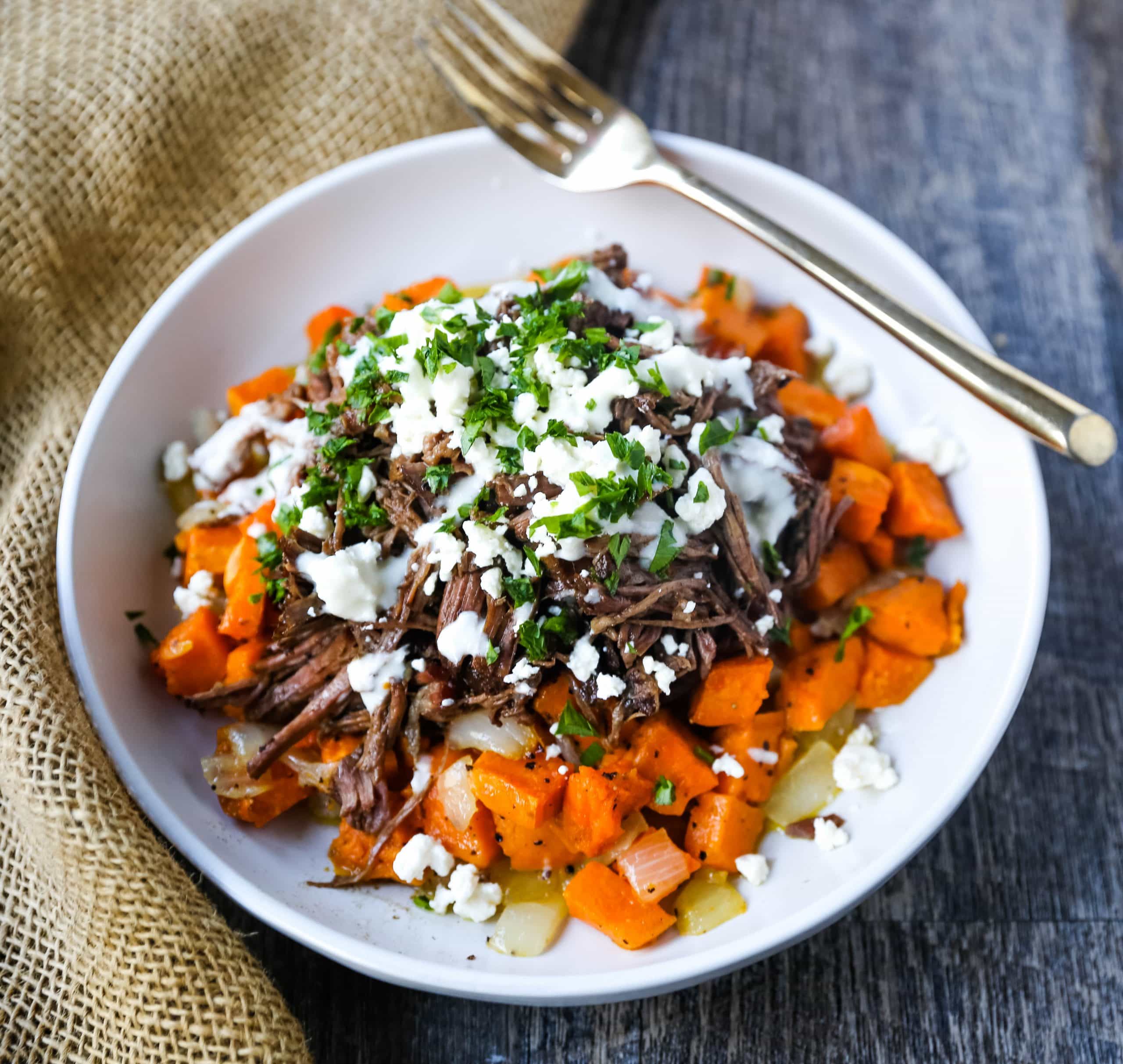 Braised Beef and Sweet Potato Hash Bowl. Tender braised beef on top of a sweet potato onion hash and topped with feta cheese and herbs. www.modernhoney.com #bowl #bowls #dinner