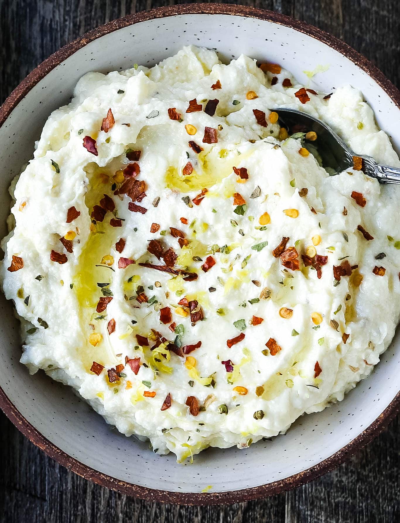 Mediterranean Creamy Feta Cheese Dip A creamy feta cheese dip with extra-virgin olive oil, feta cheese, cream cheese, garlic, fresh lemon zest, and red chili flakes. www.modernhoney.com #dip #dips #appetizer #appetizers #fetadip #fetacheesedip #superbowl