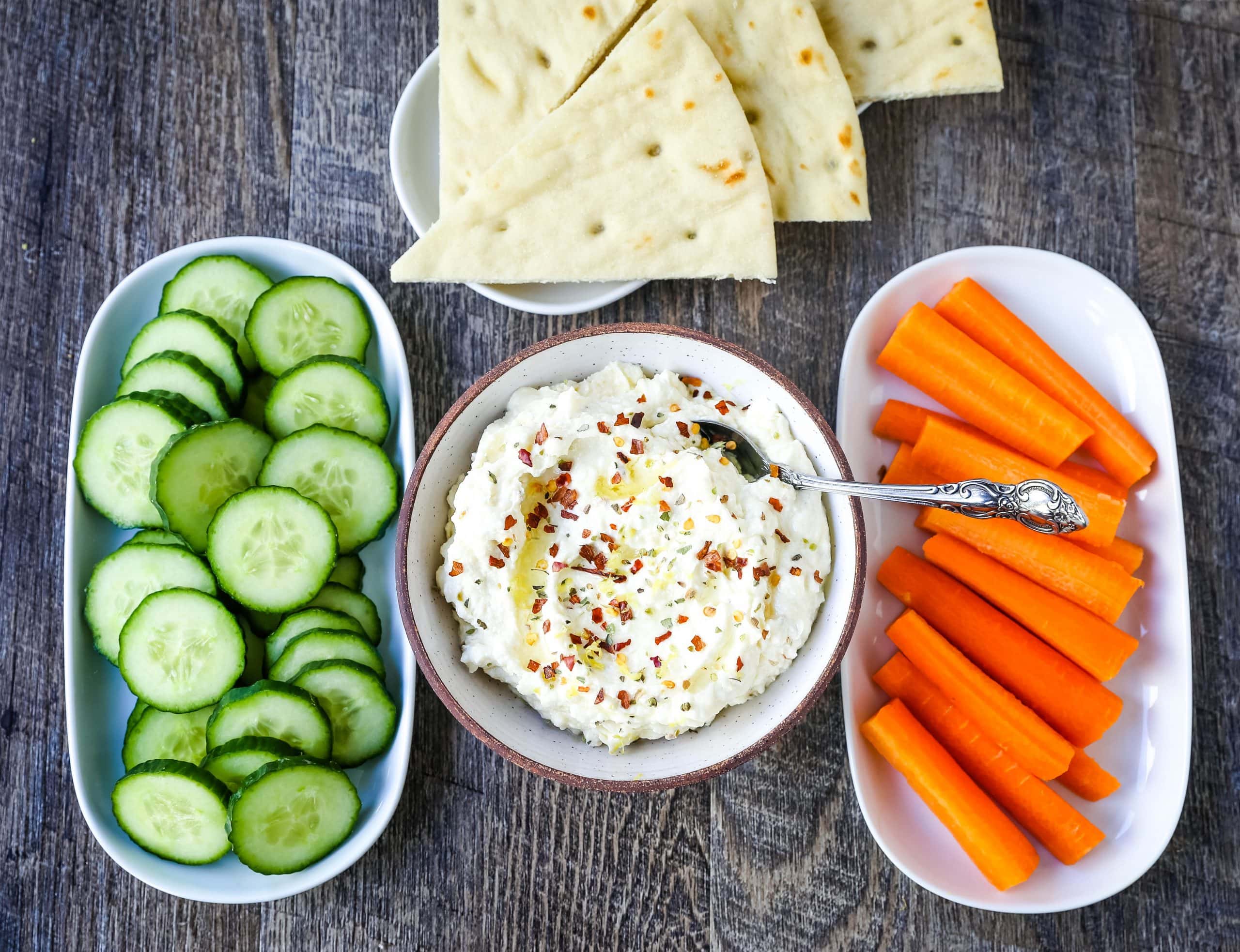 Mediterranean Creamy Feta Cheese Dip A creamy feta cheese dip with extra-virgin olive oil, feta cheese, cream cheese, garlic, fresh lemon zest, and red chili flakes. www.modernhoney.com #dip #dips #appetizer #appetizers #fetadip #fetacheesedip #superbowl