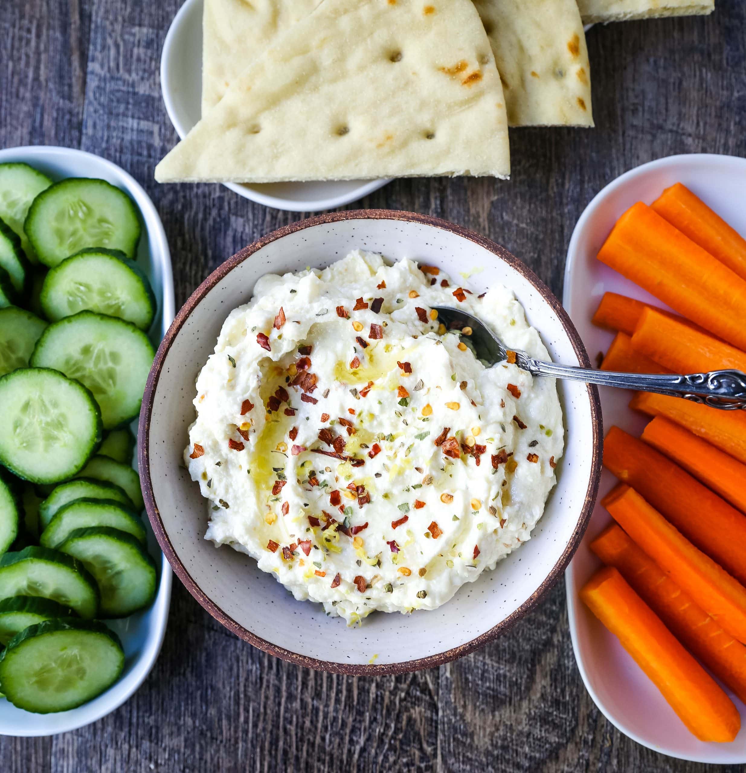 Mediterranean Creamy Feta Cheese Dip A creamy feta cheese dip with extra-virgin olive oil, feta cheese, cream cheese, garlic, fresh lemon zest, and red chili flakes. www.modernhoney.com #dip #dips #appetizer #appetizers #fetadip #fetacheesedip #superbowl