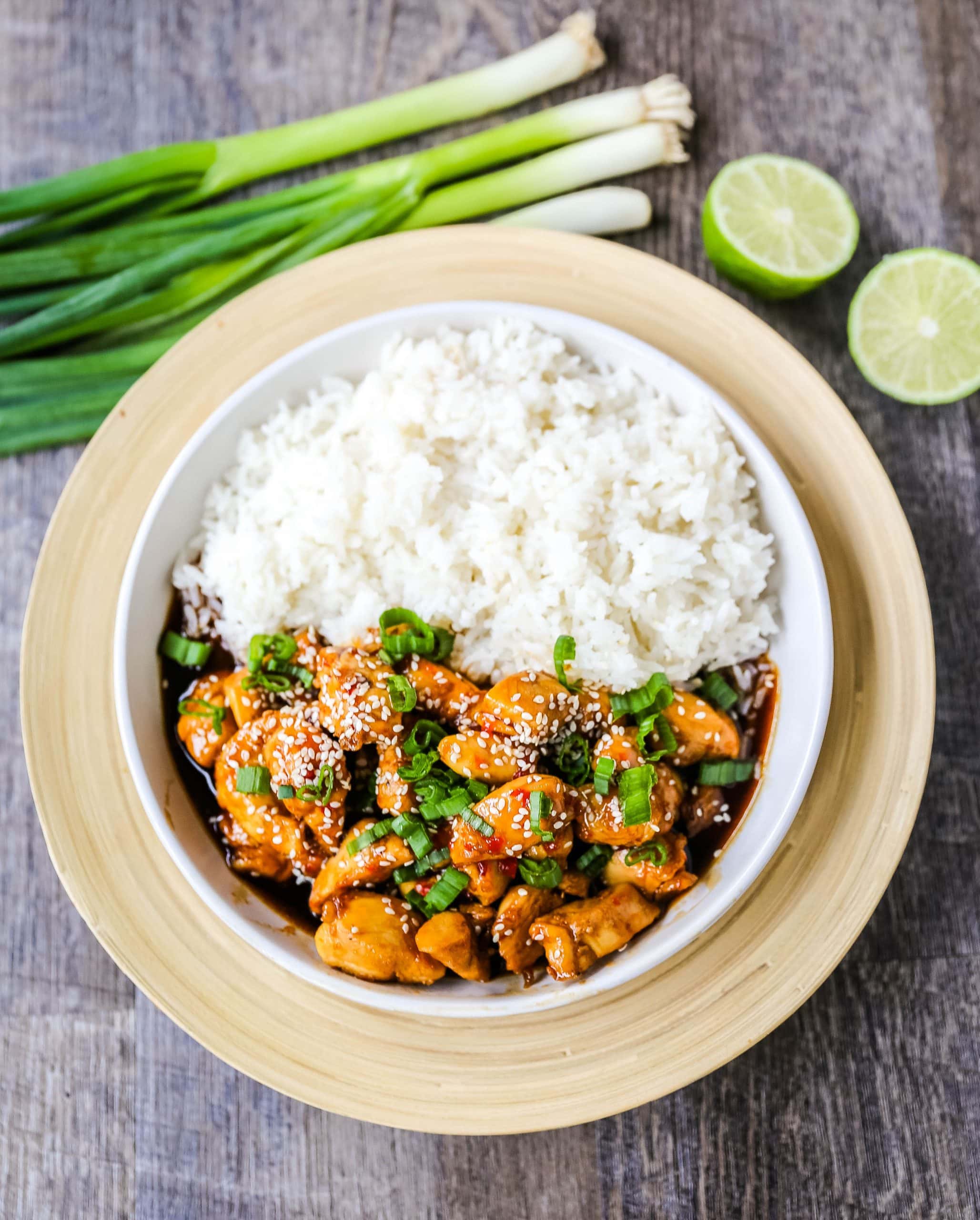 Asian Sticky Chicken Tender chicken sauteed in a sticky sweet and tangy Asian sauce served with creamy coconut rice. A quick and easy 20-minute dinner! www.modernhoney.com #asianfood #chinesefood #stickychicken #chicken 