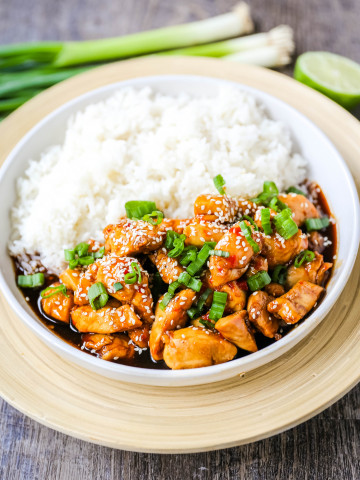 Asian Sticky Chicken Tender chicken sauteed in a sticky sweet and tangy Asian sauce served with creamy coconut rice. A quick and easy 20-minute dinner! www.modernhoney.com #asianfood #chinesefood #stickychicken #chicken