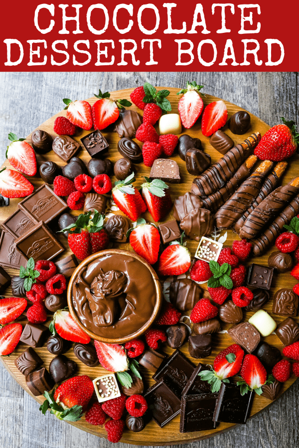 Chocolate Dessert Board A decadent chocolate board with an assortment of chocolate truffles, milk chocolate, dark chocolate hearts, chocolate covered pretzels, Nutella, berries, and more! www.modernhoney.com #chocolate #valentinesday #chocolateboard #dessert #desserts #chocolatedessert