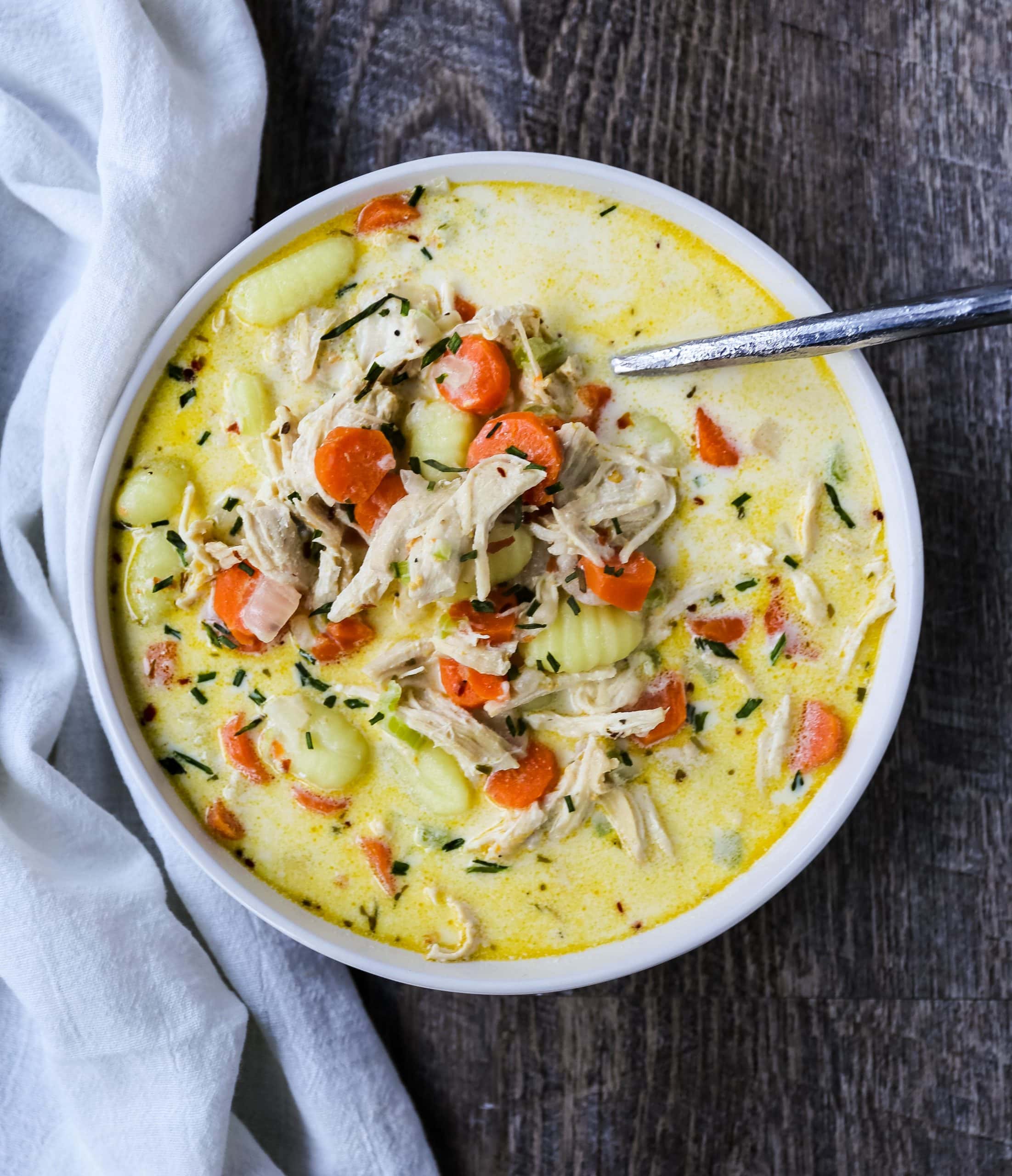 Creamy Gnocchi Chicken Soup Creamy chicken and vegetable soup with soft gnocchi pasta in a parmesan cheese creamy both. A warm, comforting bowl of comfort food! www.modernhoney.com #soup #soups #chickensoup