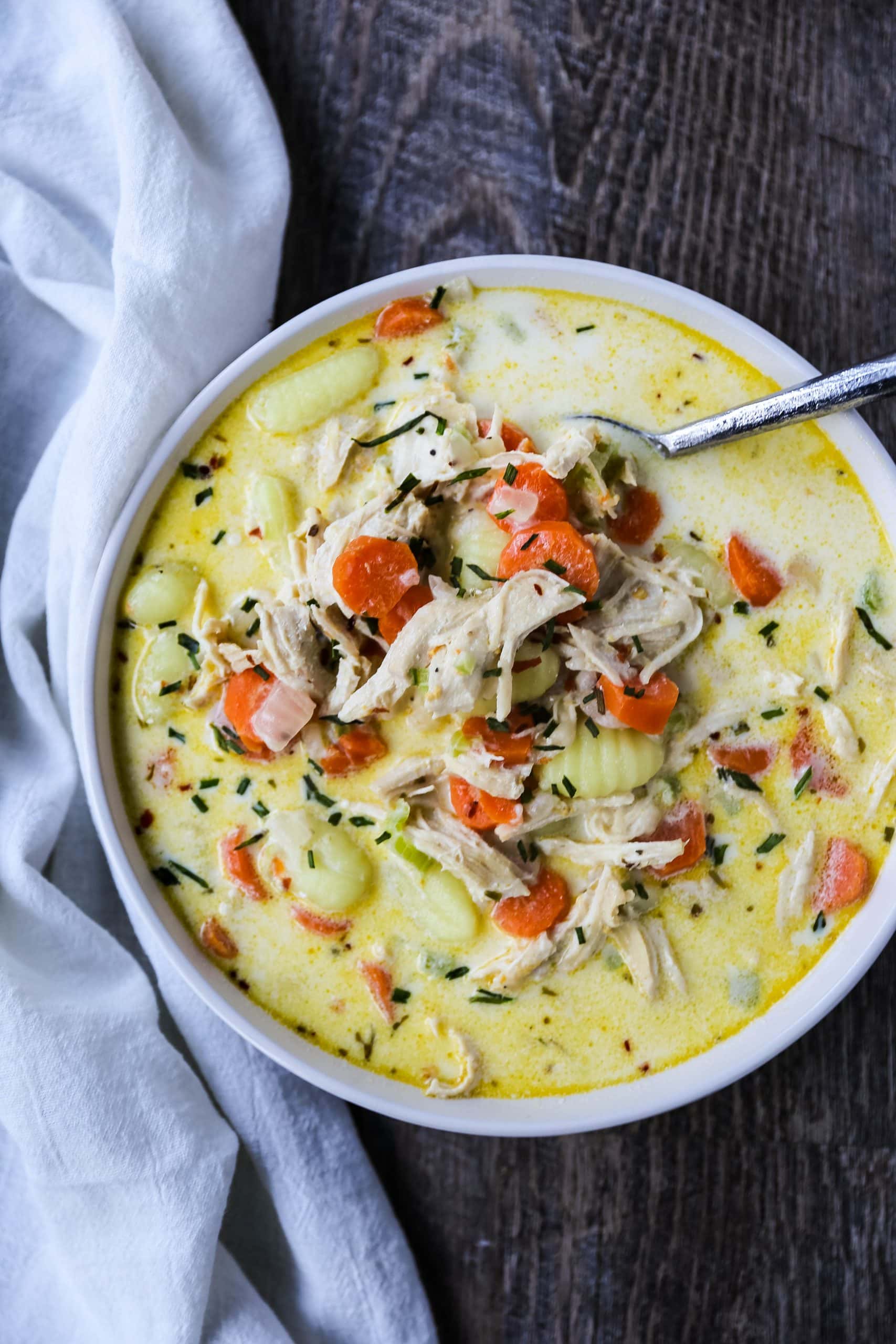 Creamy Gnocchi Chicken Soup Creamy chicken and vegetable soup with soft gnocchi pasta in a parmesan cheese creamy both. A warm, comforting bowl of comfort food! www.modernhoney.com #soup #soups #chickensoup